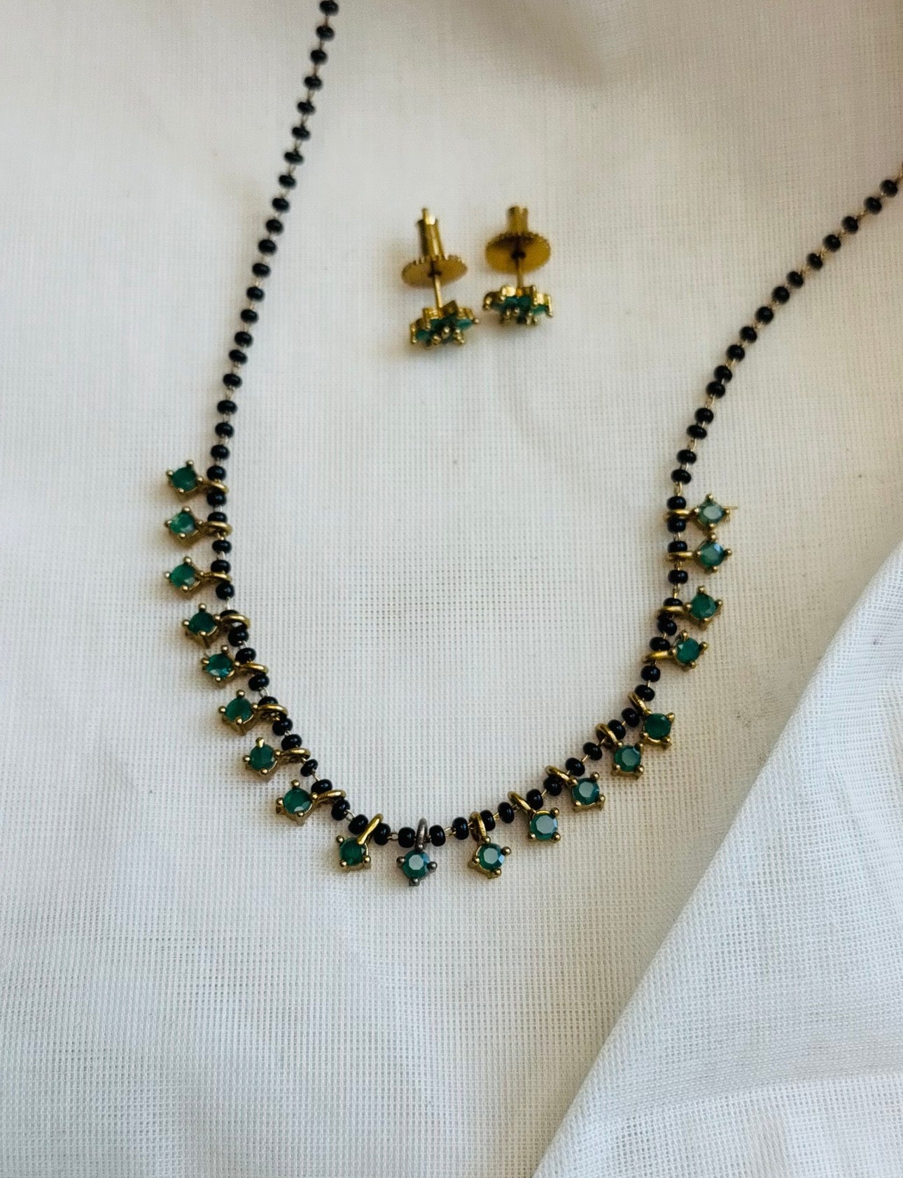 Black beaded (karimani) neckchain with green stone pendants, with earrings - YCGPNP809