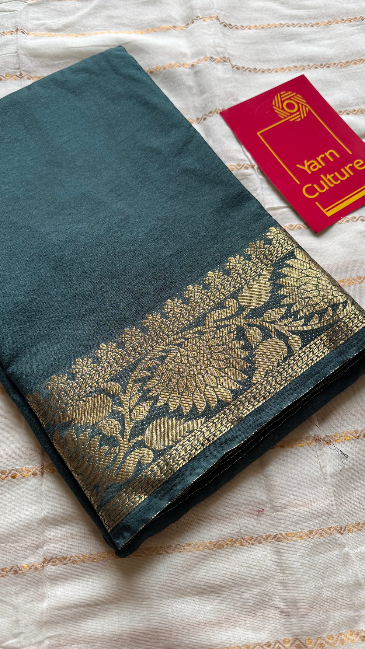 Dark green, semi crepe silk saree with antique gold floral border - YCLOKOC57