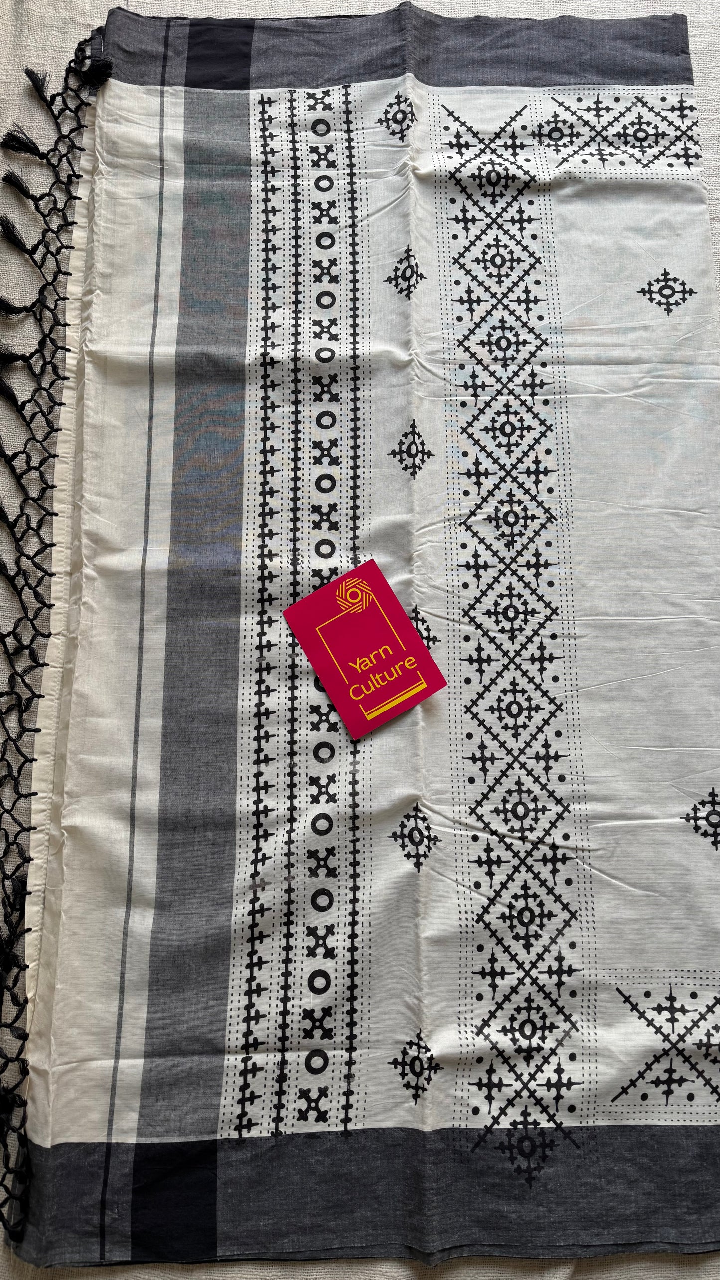 Ivory Kerala cotton saree with black Kutch-inspired printed borders and black centre pleats - YCIEKCFE312