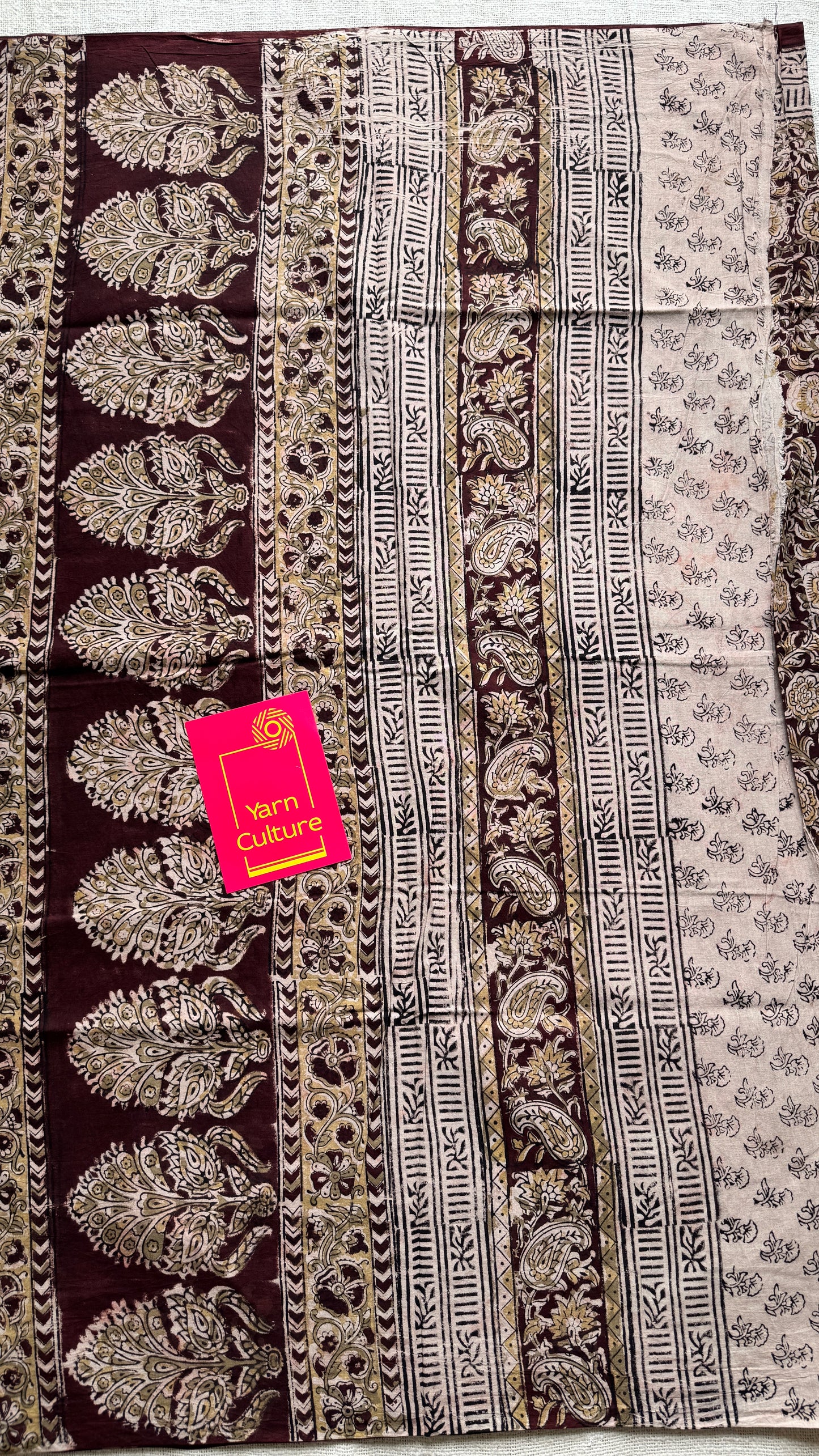 Dark maroon kalamkari, yellow floral vines, floral motif pallu