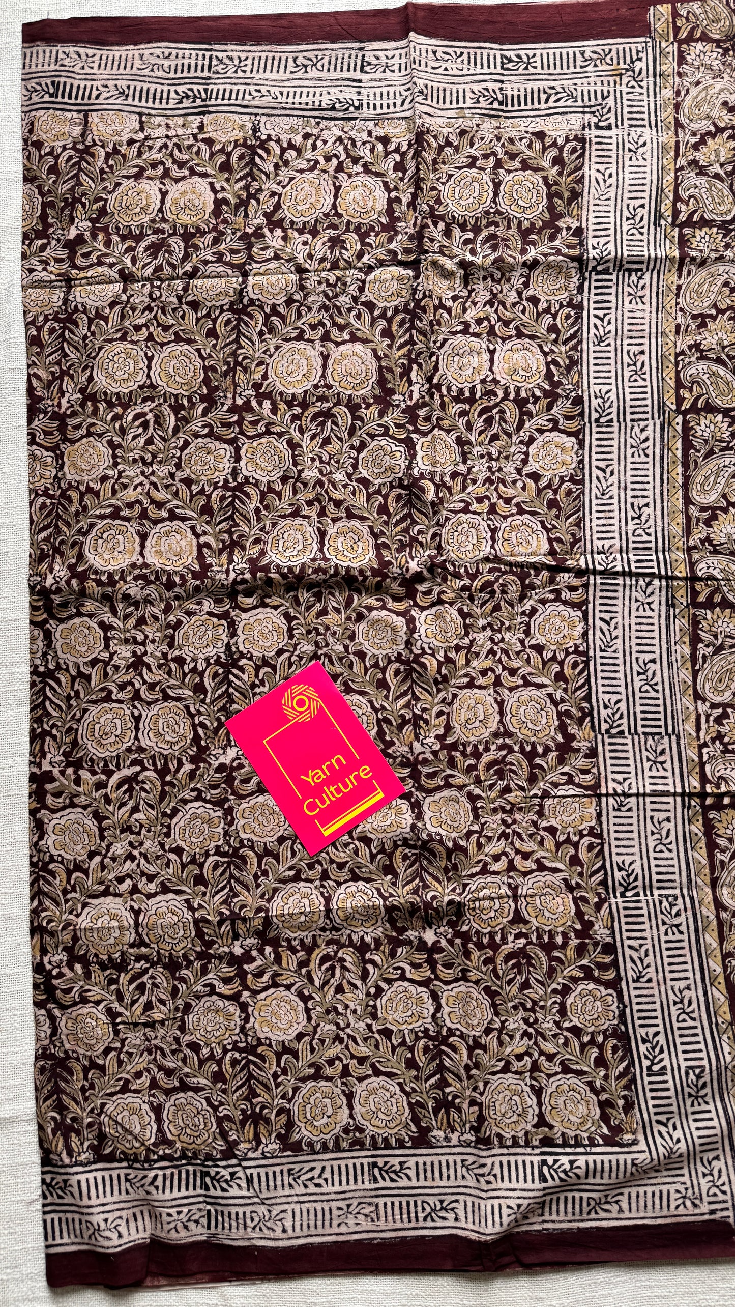 Dark maroon kalamkari, yellow floral vines, floral motif pallu