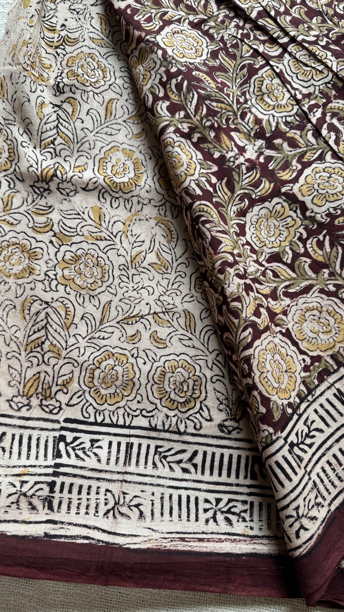 Dark maroon kalamkari, yellow floral vines, floral motif pallu