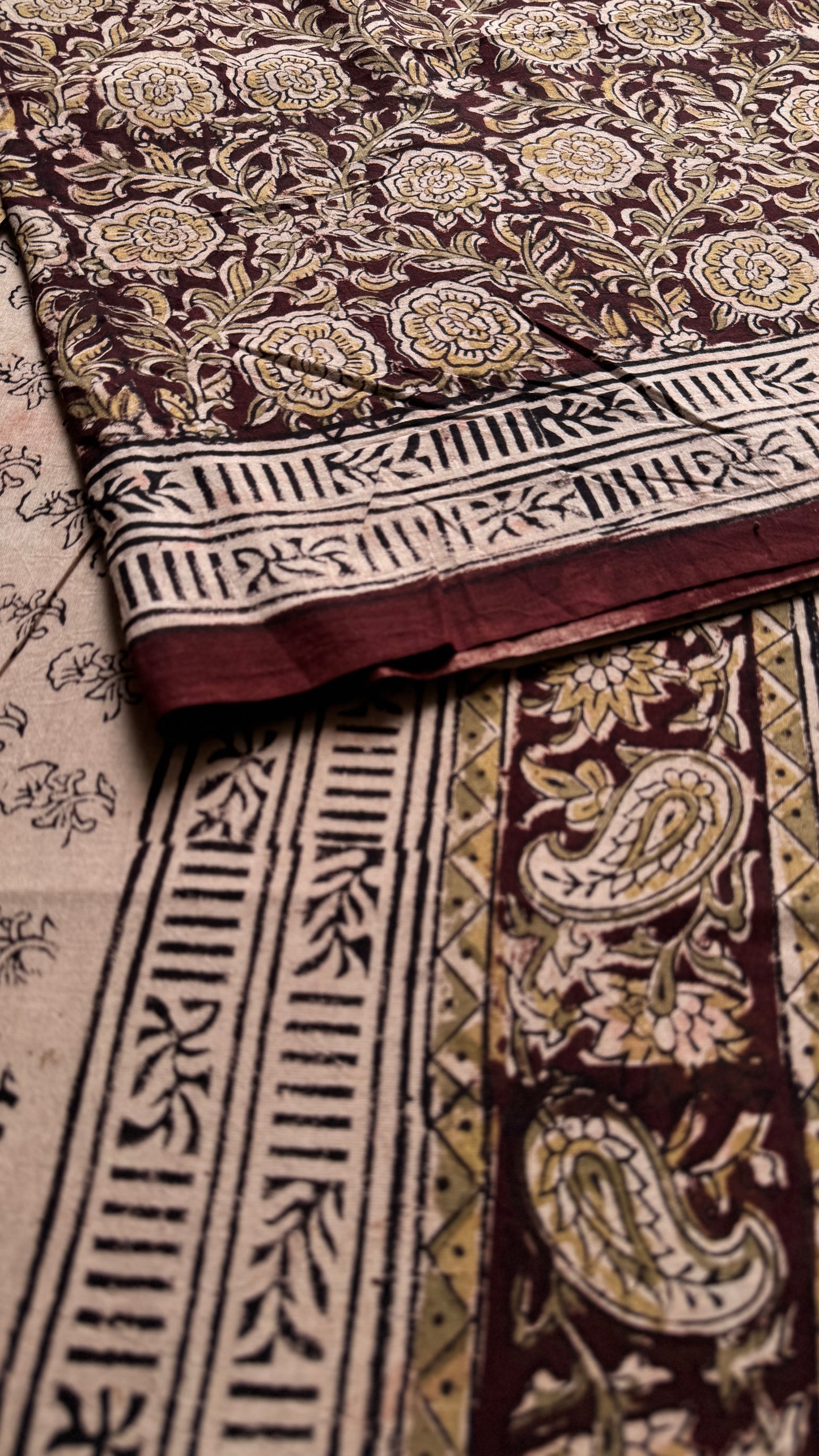 Dark maroon kalamkari, yellow floral vines, floral motif pallu