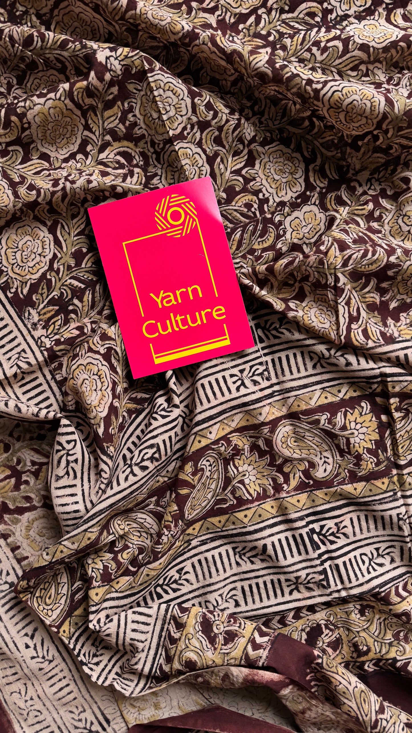 Dark maroon kalamkari, yellow floral vines, floral motif pallu