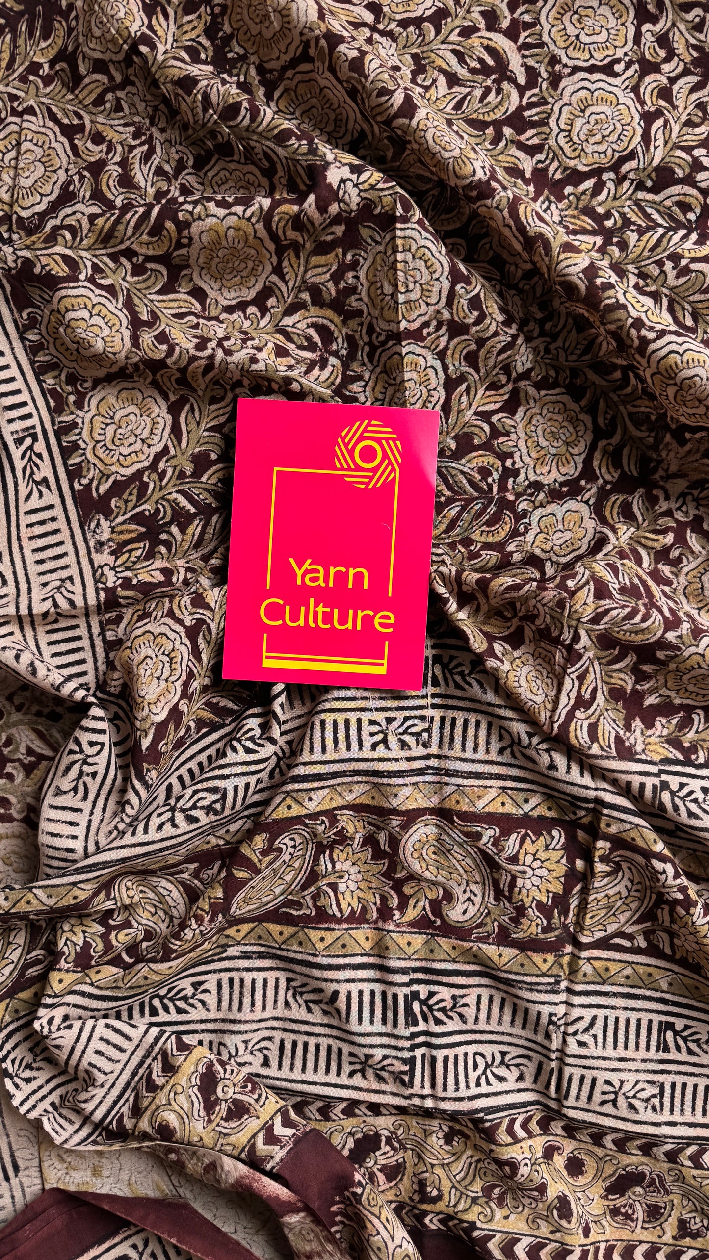 Dark maroon kalamkari, yellow floral vines, floral motif pallu