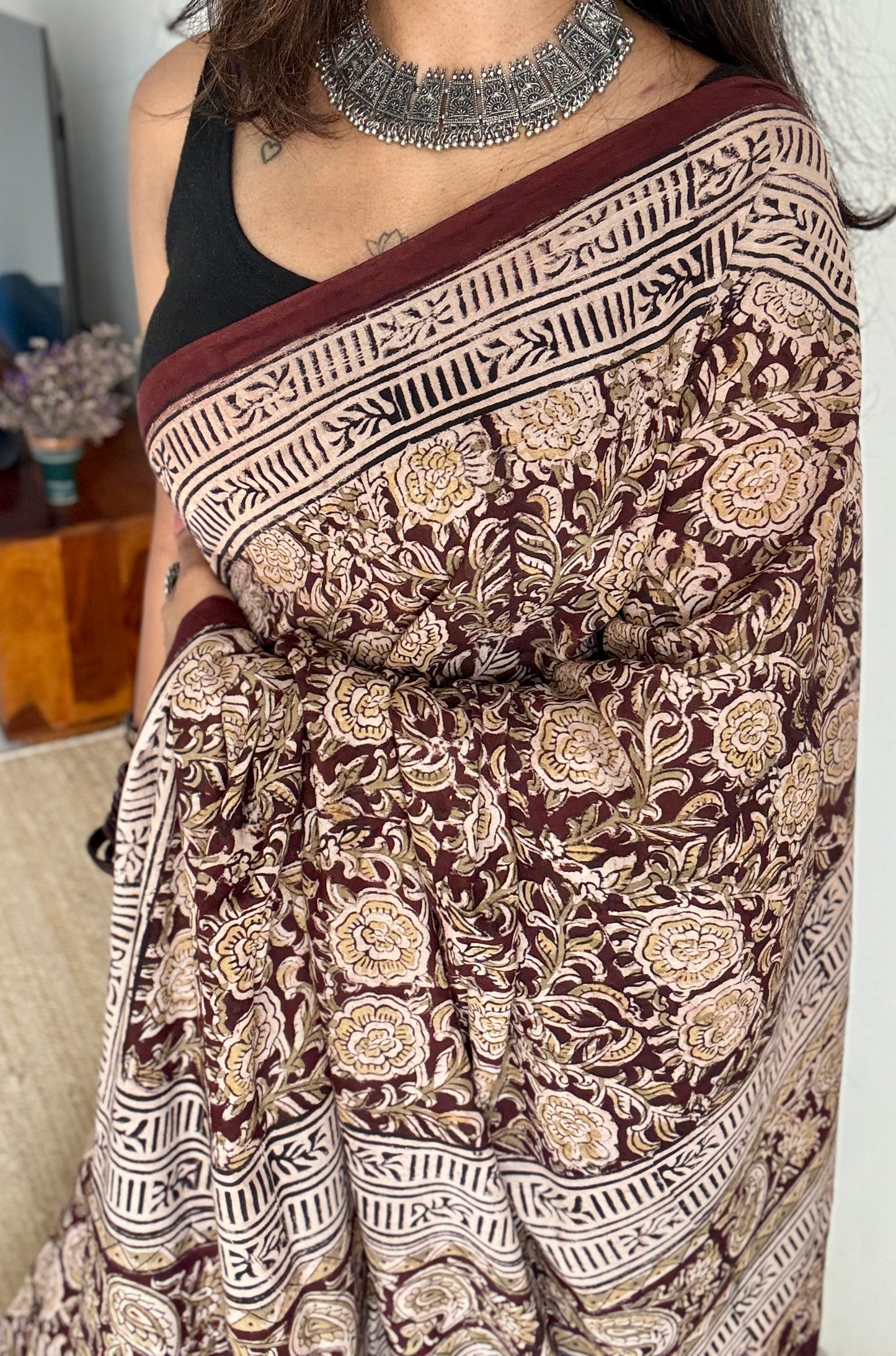 Dark maroon kalamkari, yellow floral vines, floral motif pallu