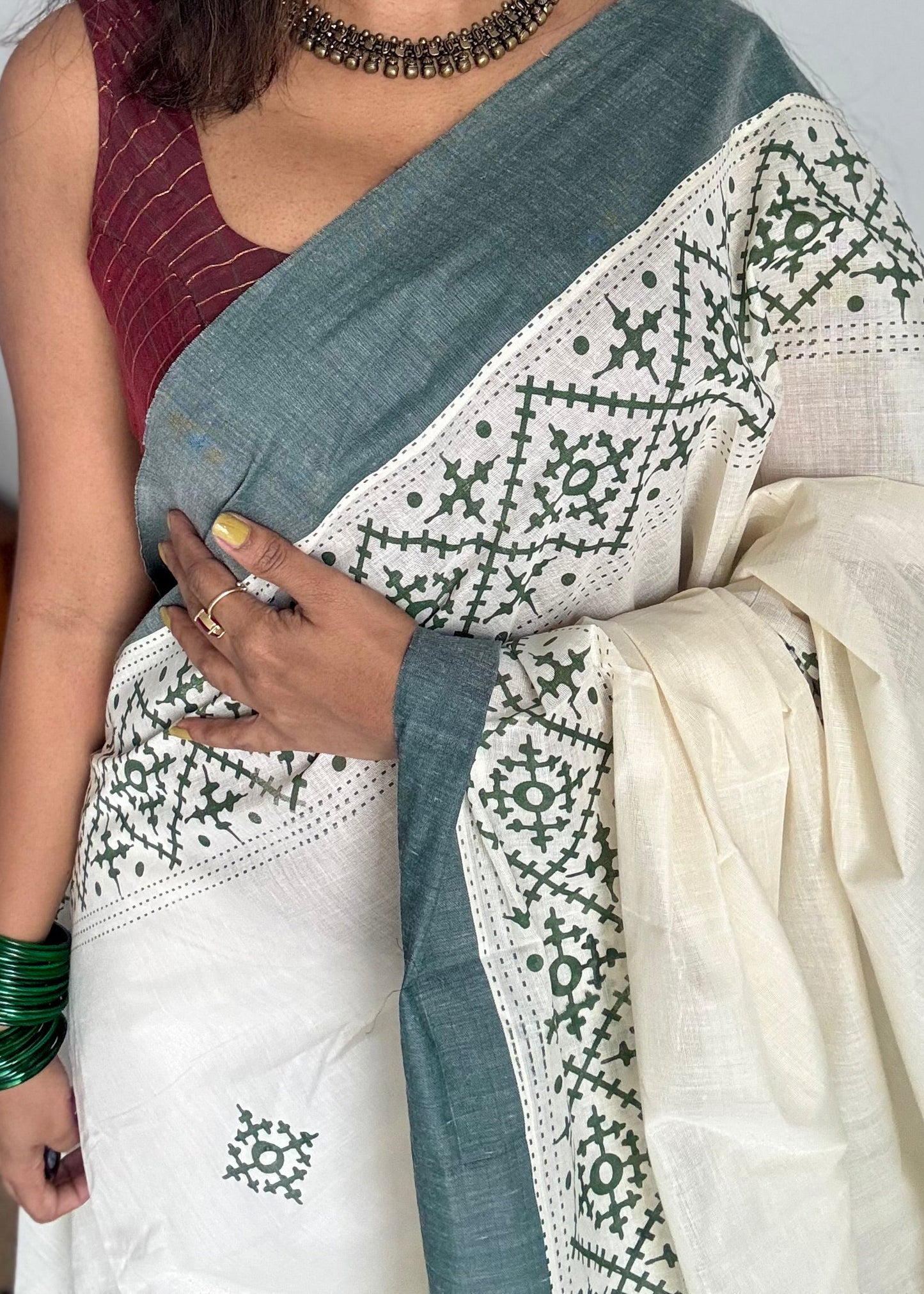 Ivory Kerala cotton saree with green Kutch-inspired printed borders and green centre pleats - YCIEKCFE314