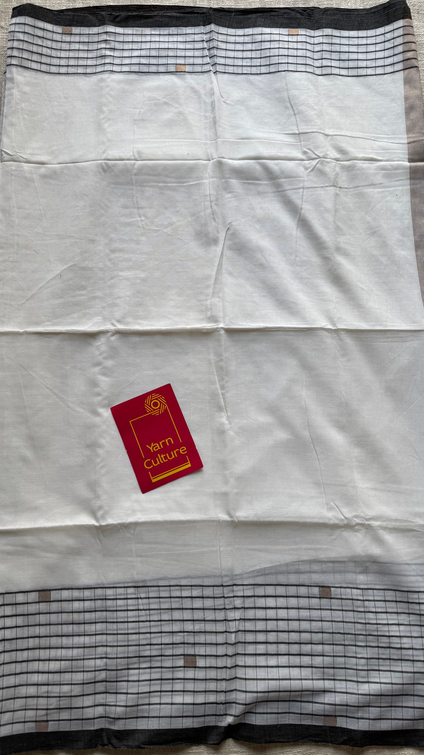 Ivory handloom mul saree with black checkered borders and antique gold buttas - YCBCMCFE170