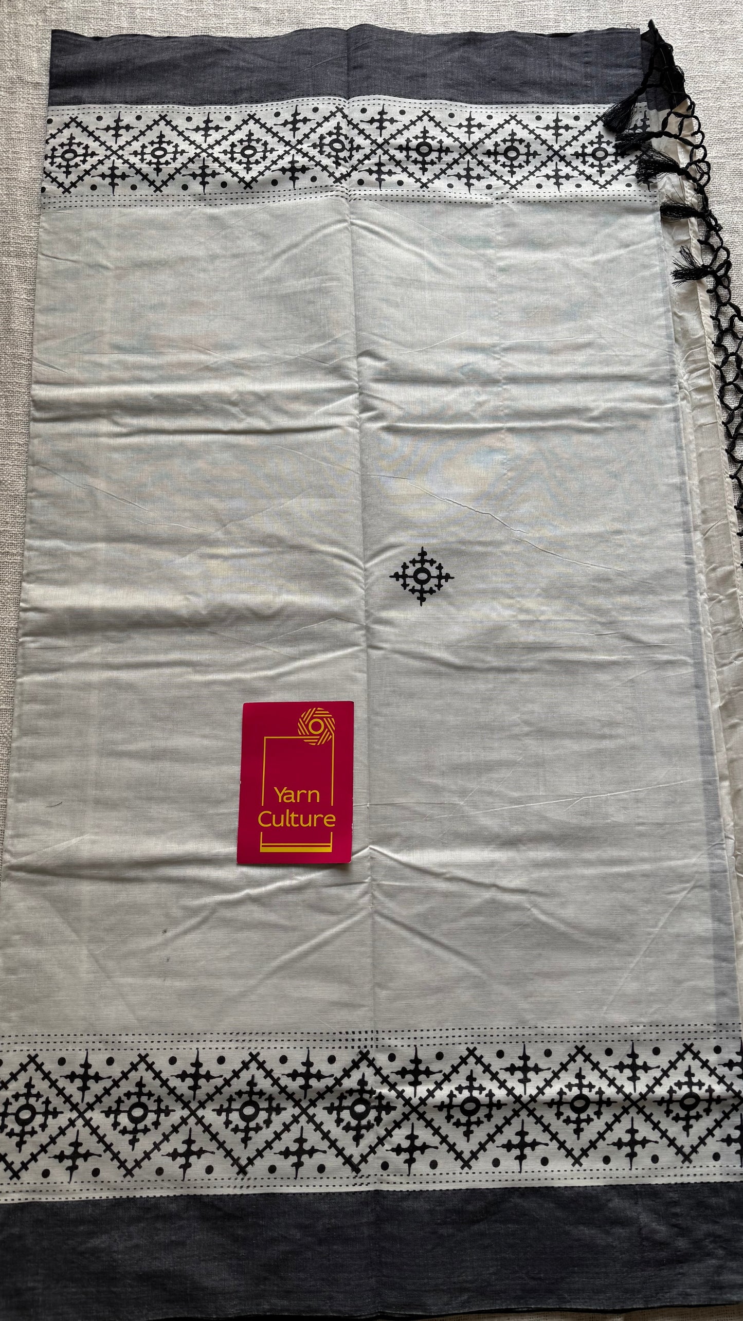 Ivory Kerala cotton saree with black Kutch-inspired printed borders and black centre pleats - YCIEKCFE312