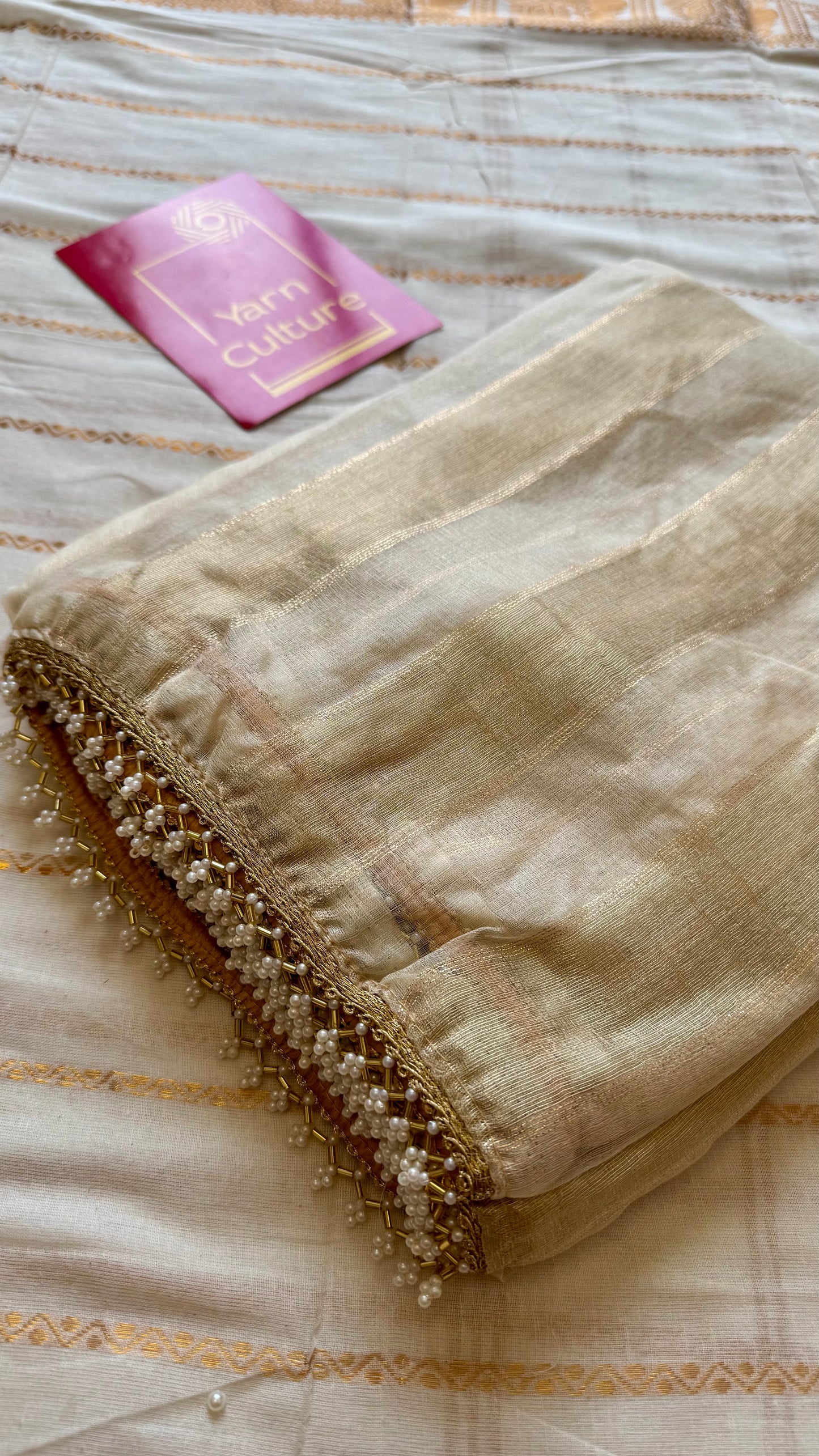 Gold soft semi tissue saree, striped body, pearl embellished border - YCIEON83