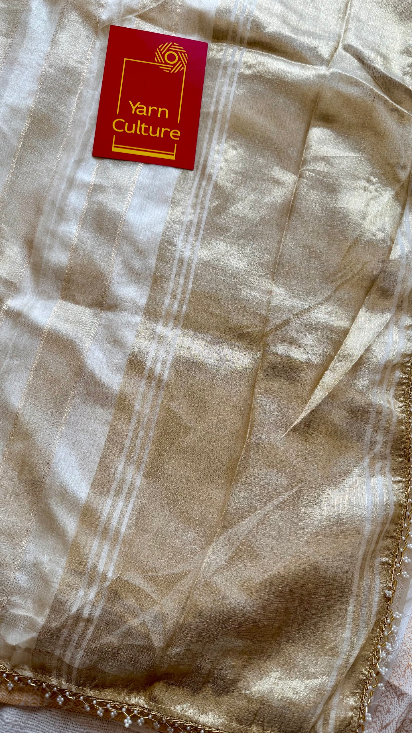 Gold soft semi tissue saree, striped body, pearl embellished border - YCIEON83