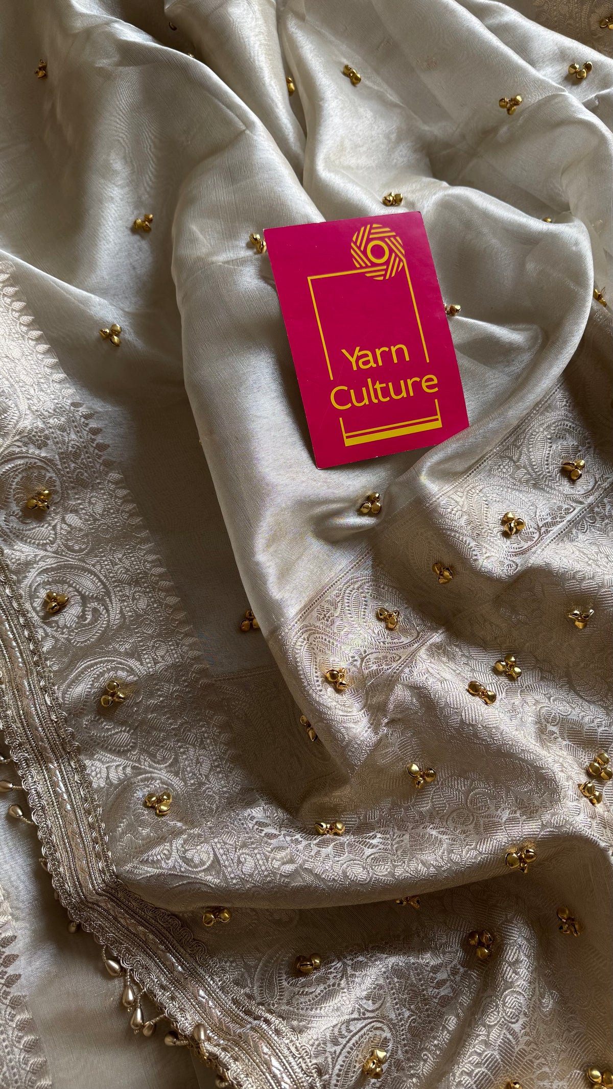 Ivory gold tissue Banarasi saree with ghungroo embellishments and beaded lace zari border - YCBLTOC70