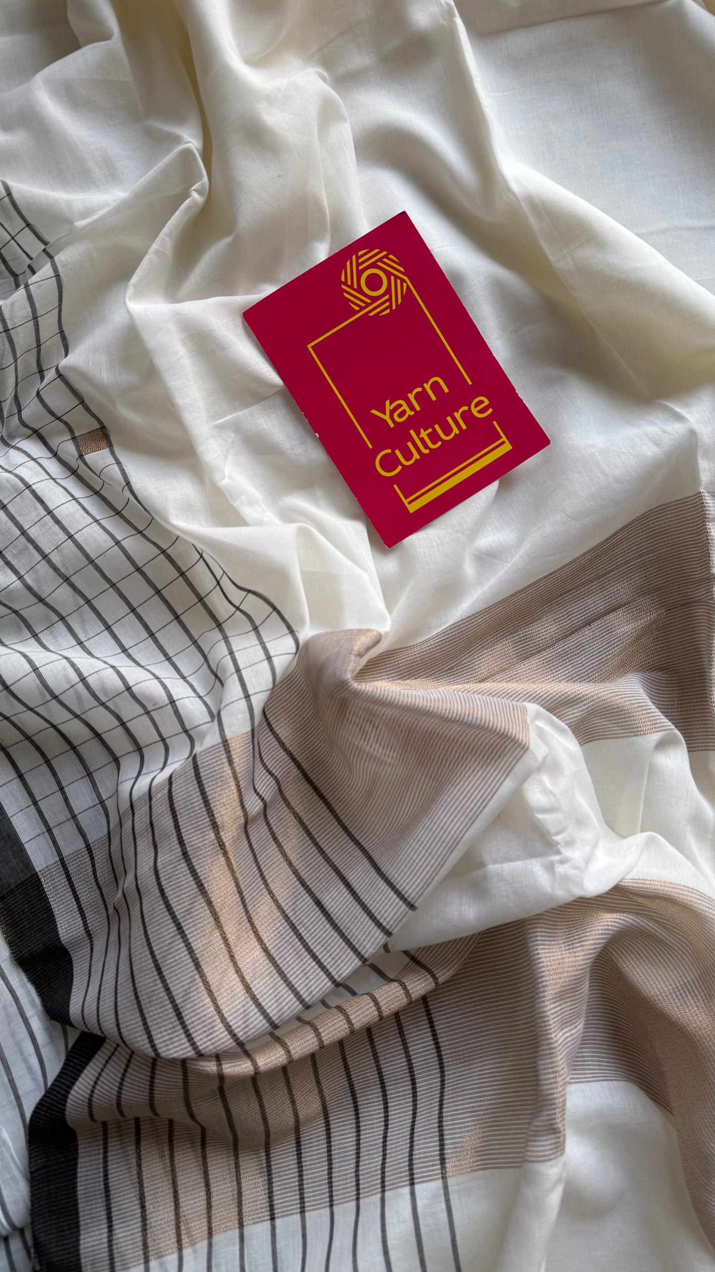 Ivory handloom mul saree with black checkered borders and antique gold buttas - YCBCMCFE170