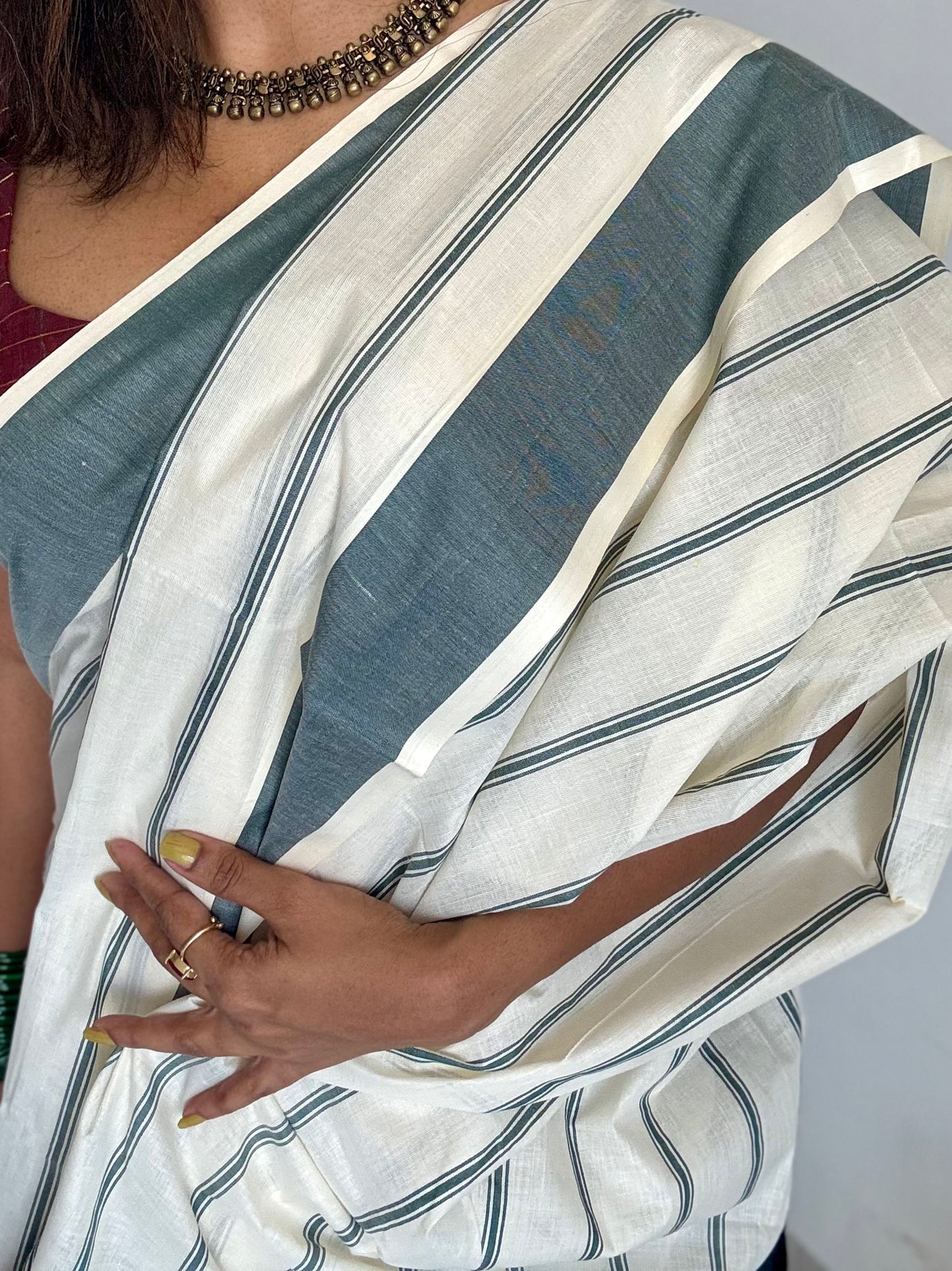 Ivory Kerala cotton saree with green stripes and border - YCIEKCFE323