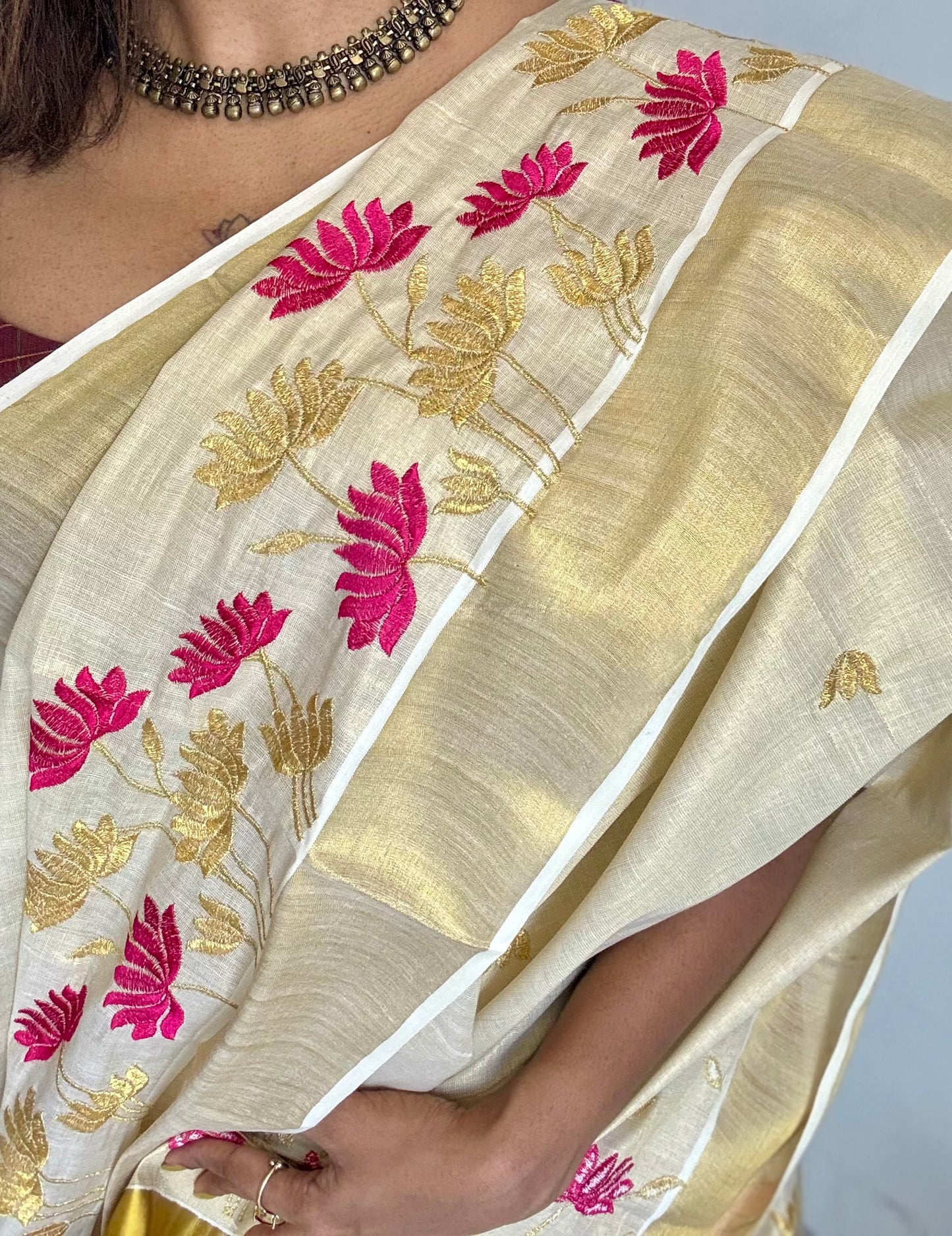 Ivory and gold tissue kerala cotton saree with hot pink and gold lotus embroidery - YCIEKCFE315