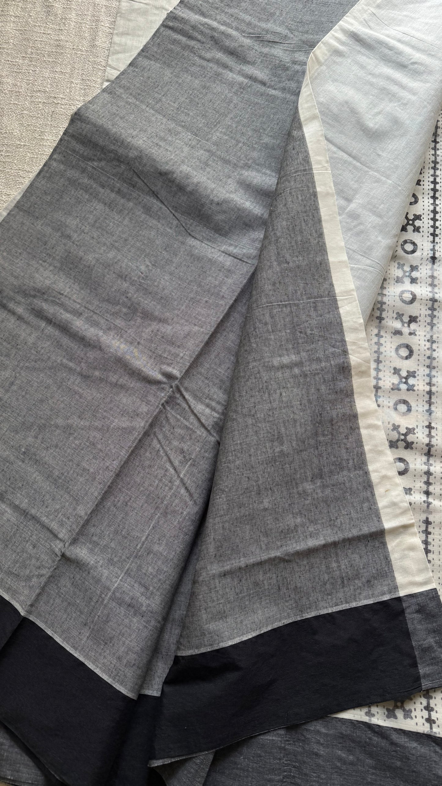 Ivory Kerala cotton saree with black Kutch-inspired printed borders and black centre pleats - YCIEKCFE312