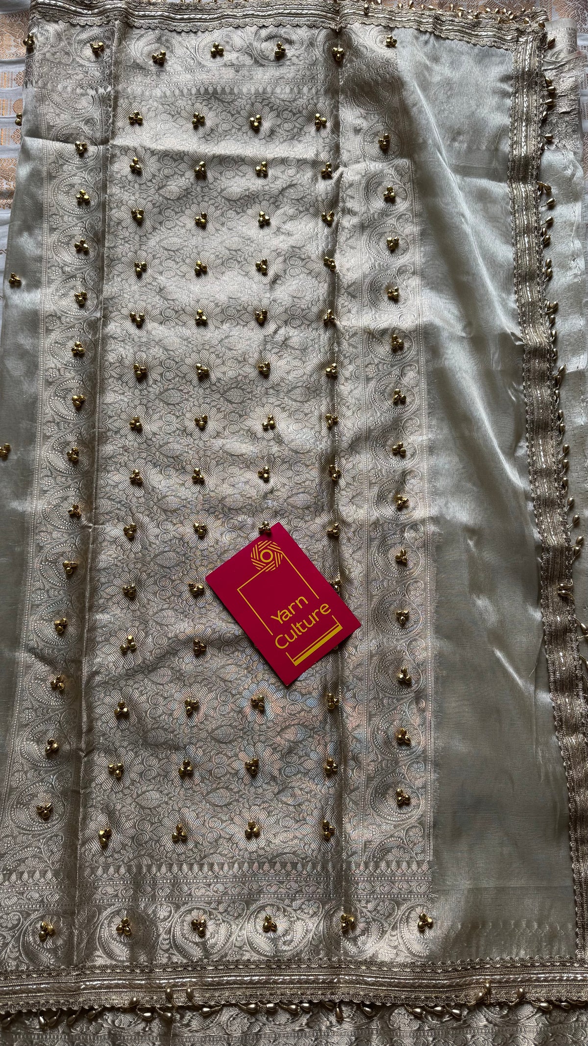 Ivory gold tissue Banarasi saree with ghungroo embellishments and beaded lace zari border - YCBLTOC70