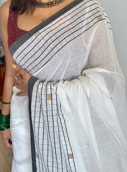 Ivory handloom mul saree with black checkered borders and antique gold buttas - YCBCMCFE170