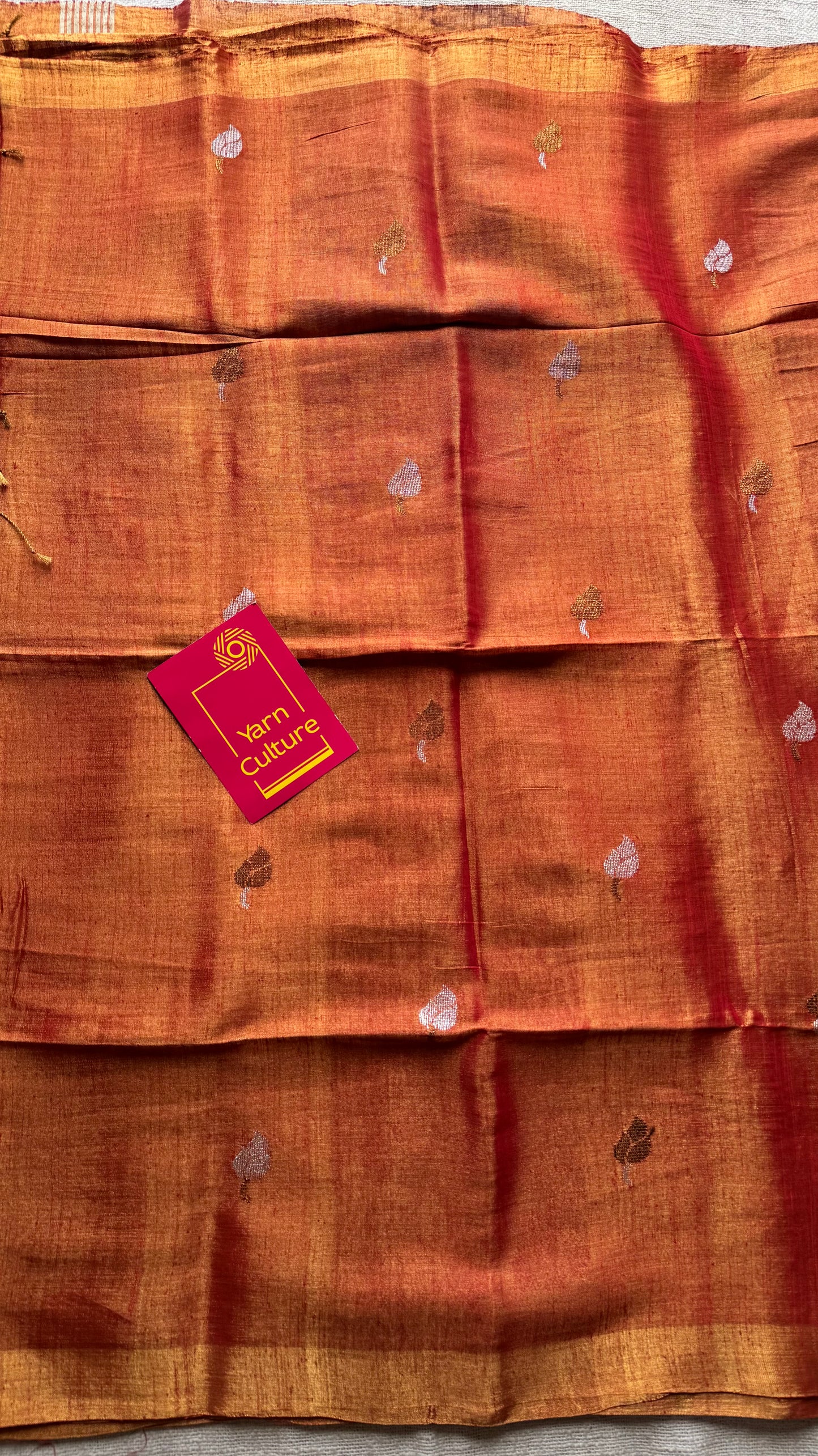 Handwoven orange gold dual tone tissue linen saree with lotus motifs - YCBCLTFE399