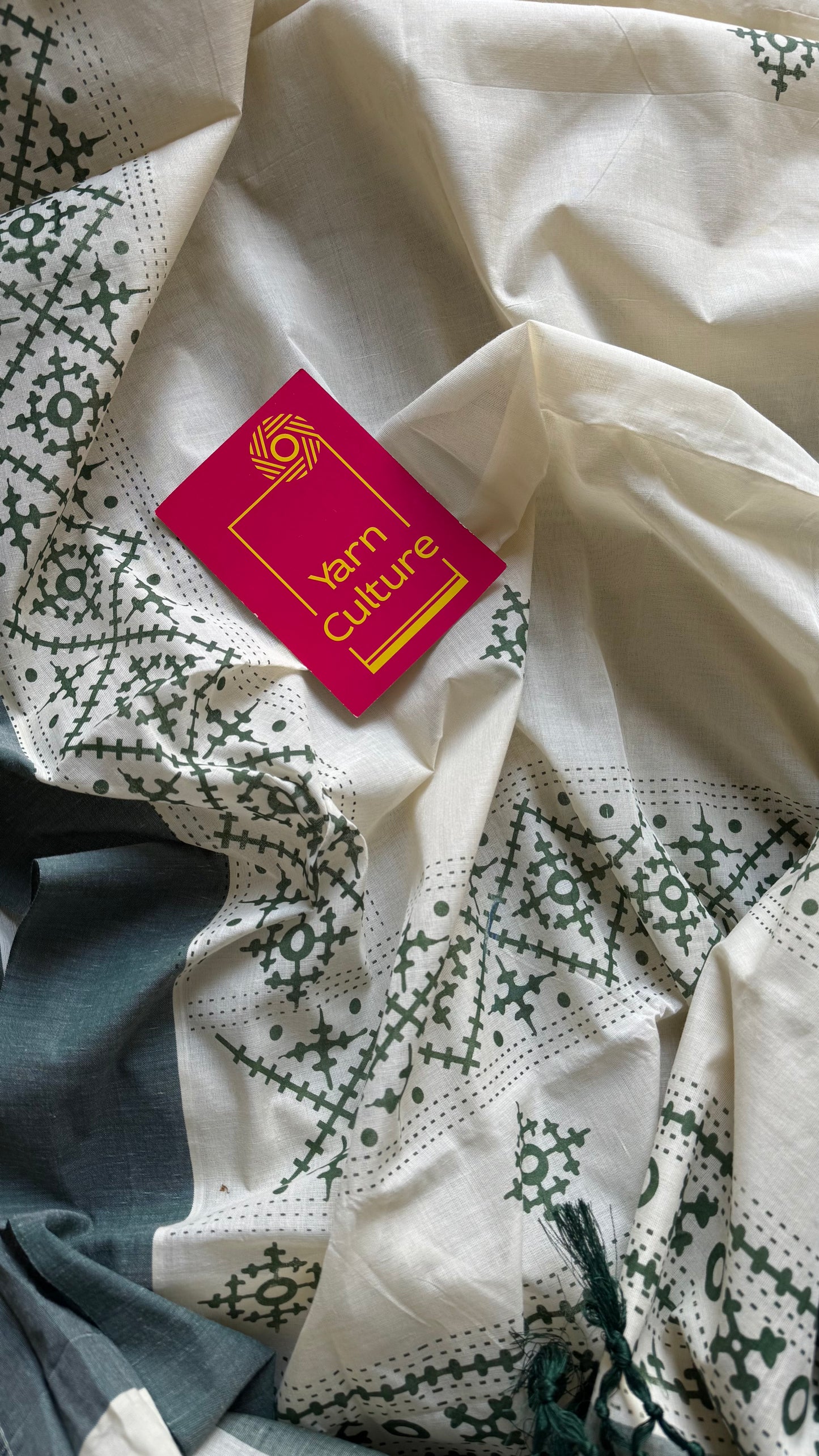 Ivory Kerala cotton saree with green Kutch-inspired printed borders and green centre pleats - YCIEKCFE314