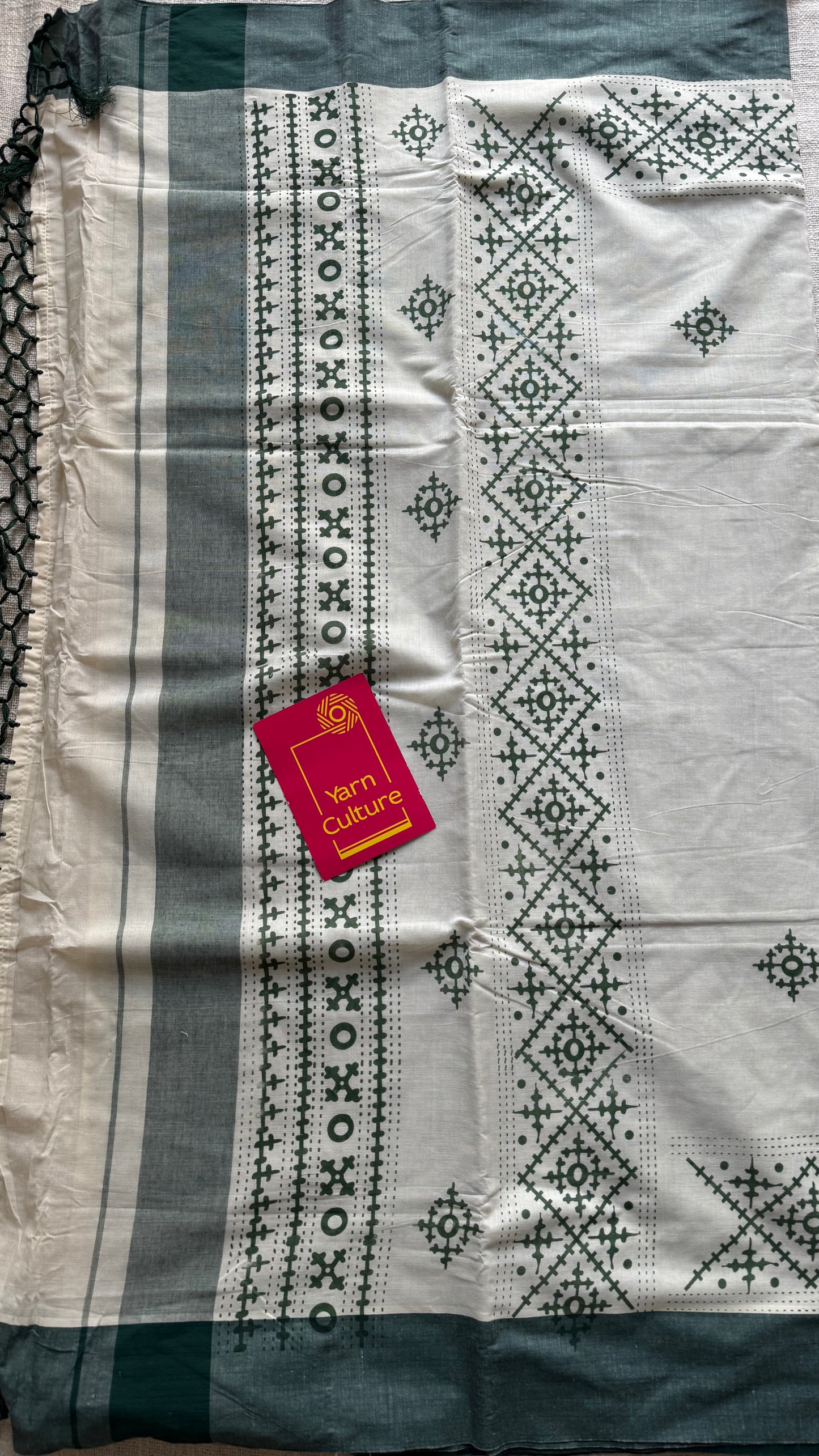 Ivory Kerala cotton saree with green Kutch-inspired printed borders and green centre pleats - YCIEKCFE314