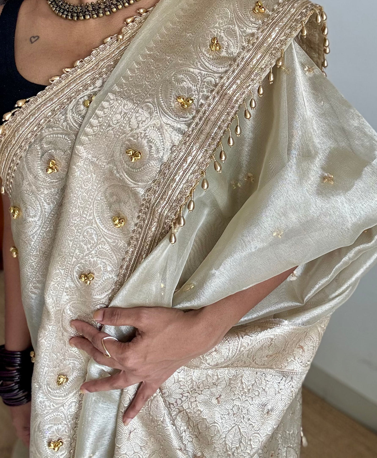 Ivory gold tissue Banarasi saree with ghungroo embellishments and beaded lace zari border - YCBLTOC70