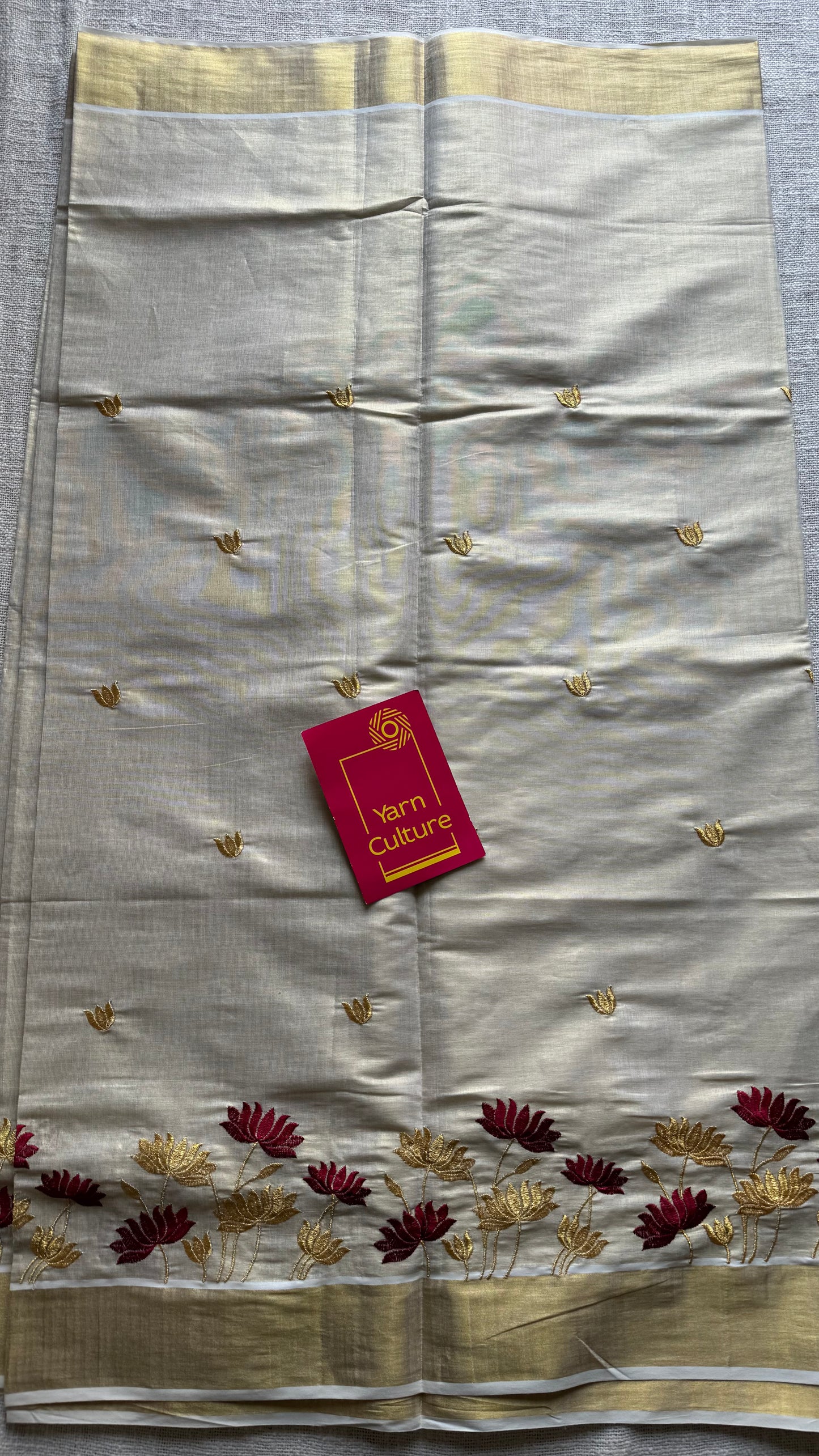 Ivory and gold tissue kerala cotton saree with maroon and gold lotus embroidery - YCIEKCFE316