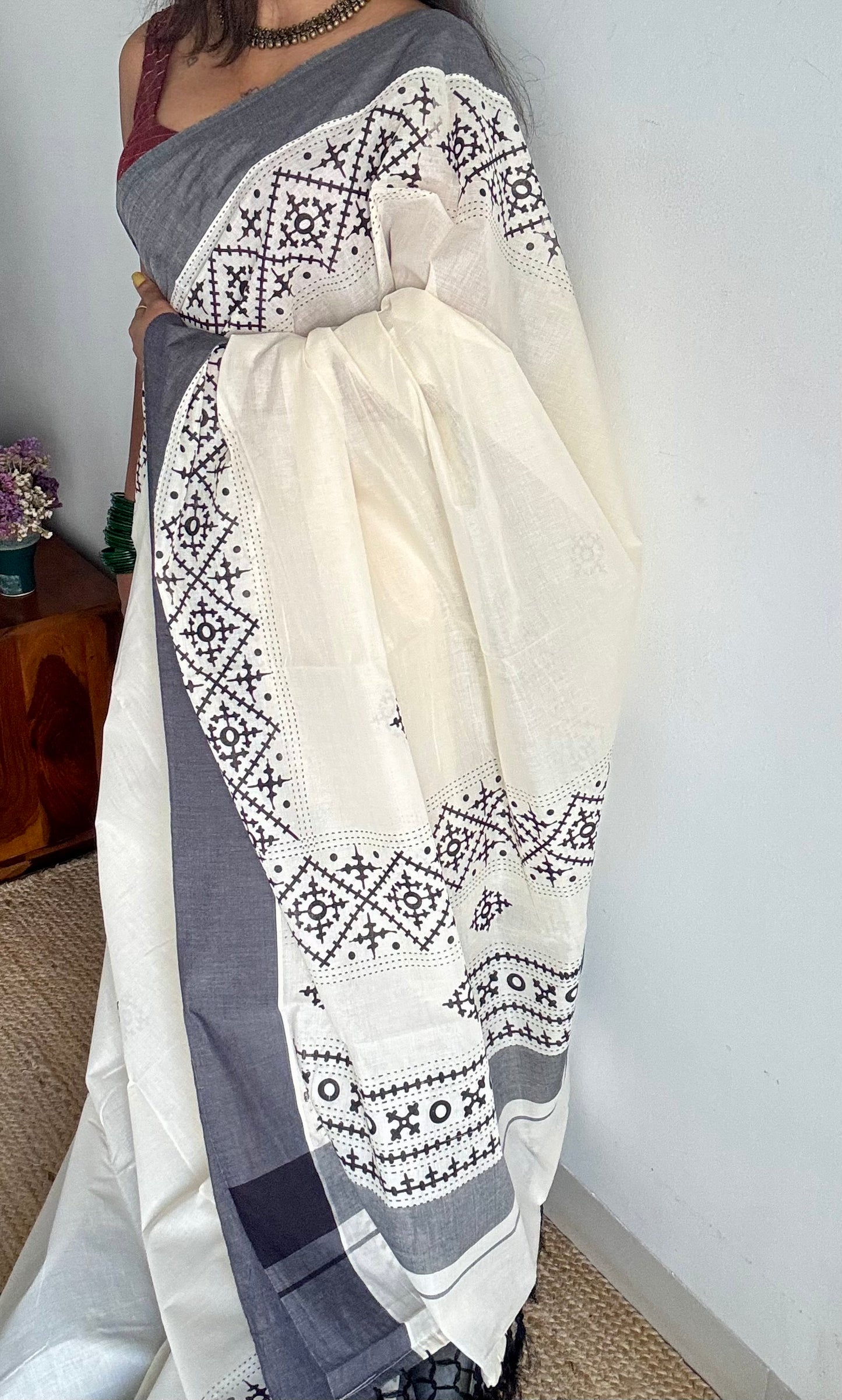 Ivory Kerala cotton saree with black Kutch-inspired printed borders and black centre pleats - YCIEKCFE312