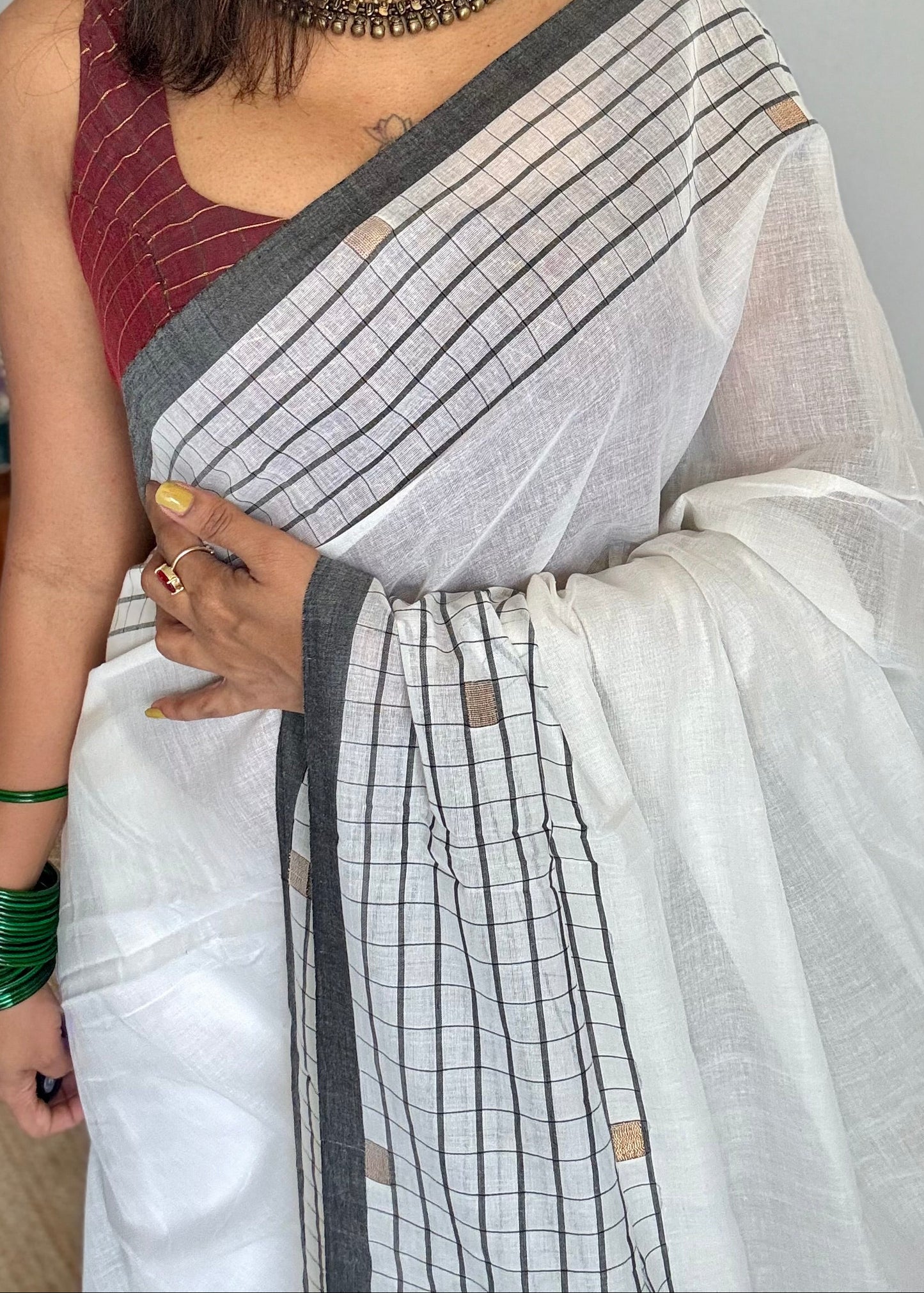 Ivory handloom mul saree with black checkered borders and antique gold buttas - YCBCMCFE170