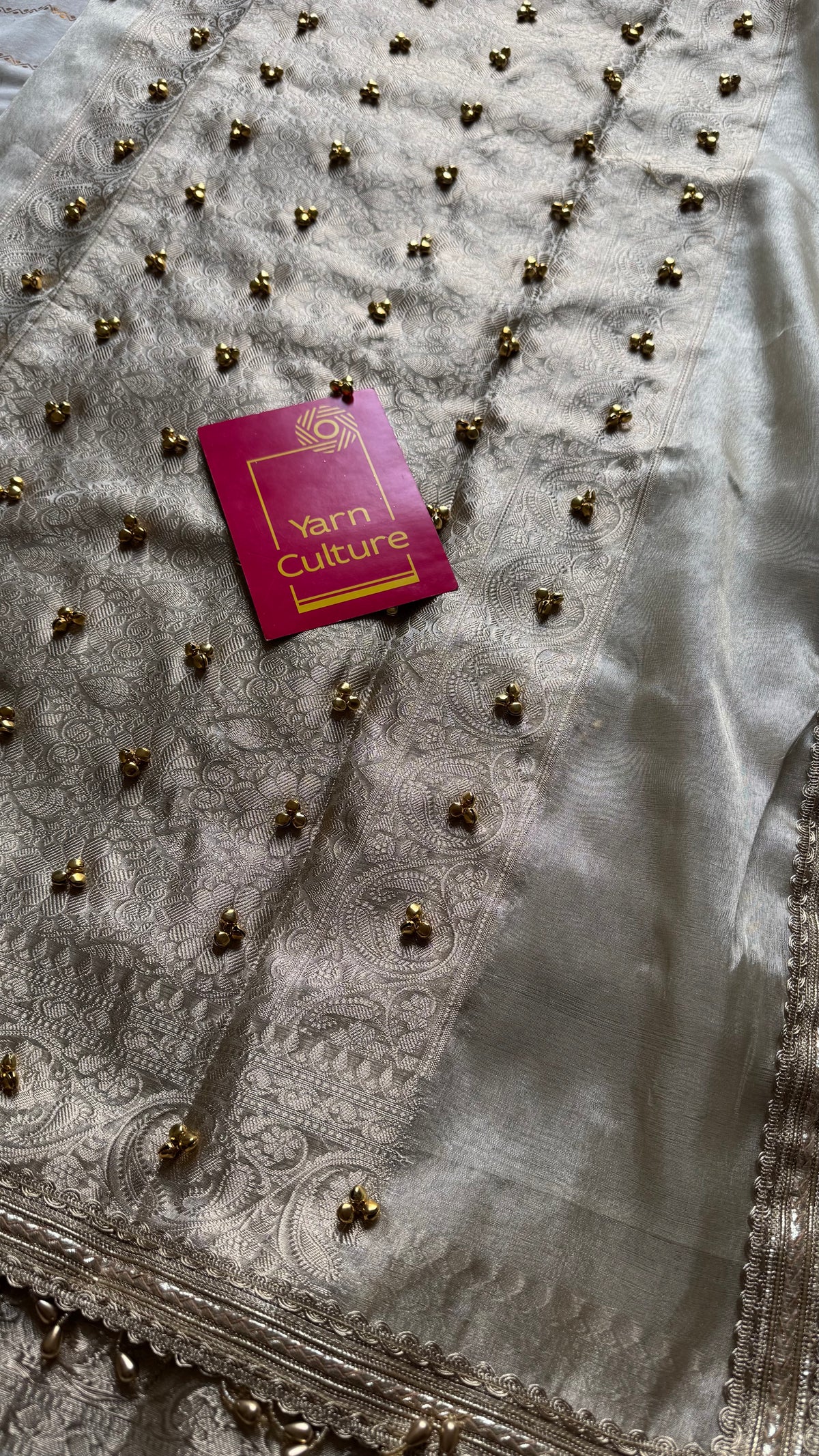 Ivory gold tissue Banarasi saree with ghungroo embellishments and beaded lace zari border - YCBLTOC70