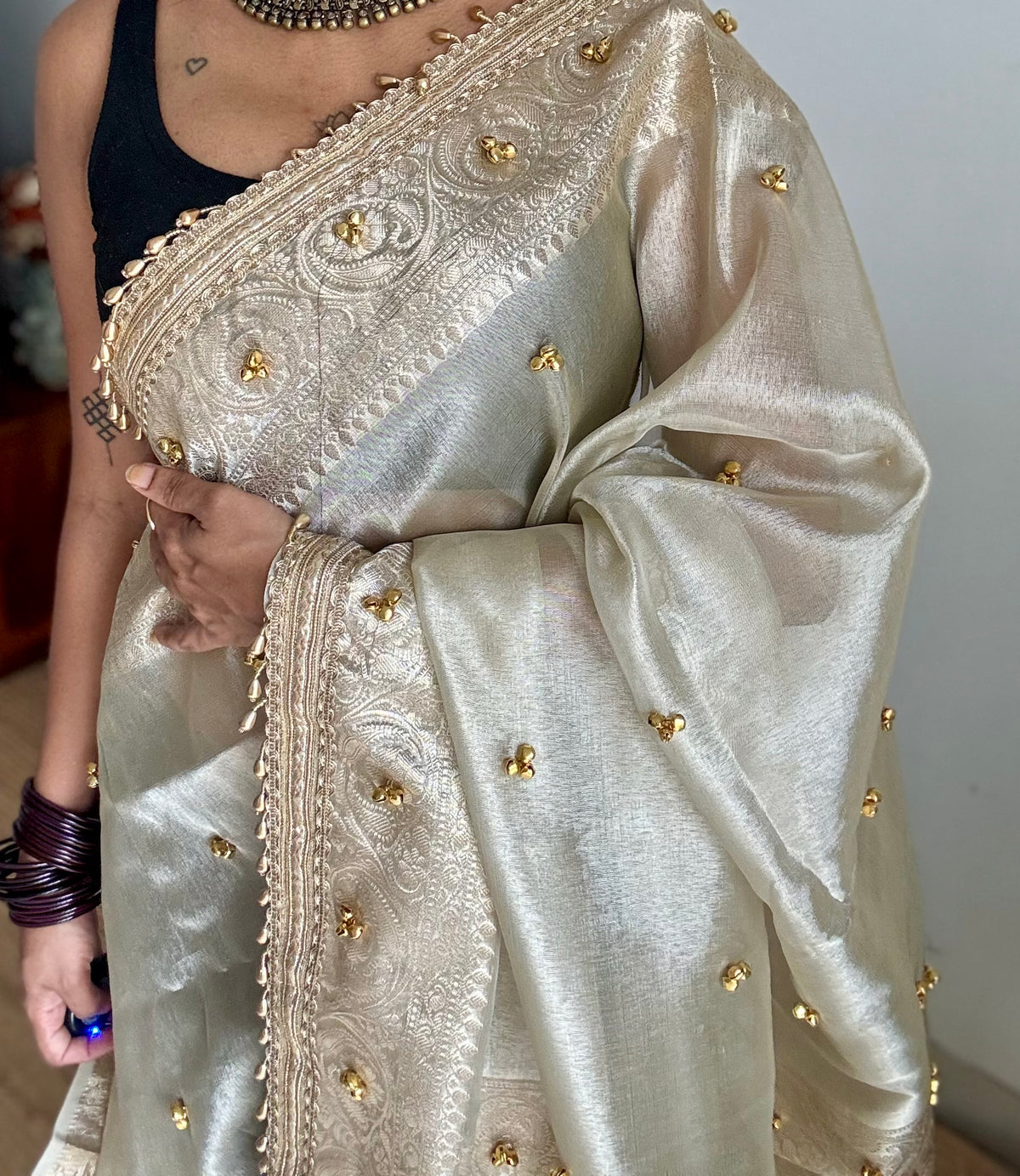 Ivory gold tissue Banarasi saree with ghungroo embellishments and beaded lace zari border - YCBLTOC70