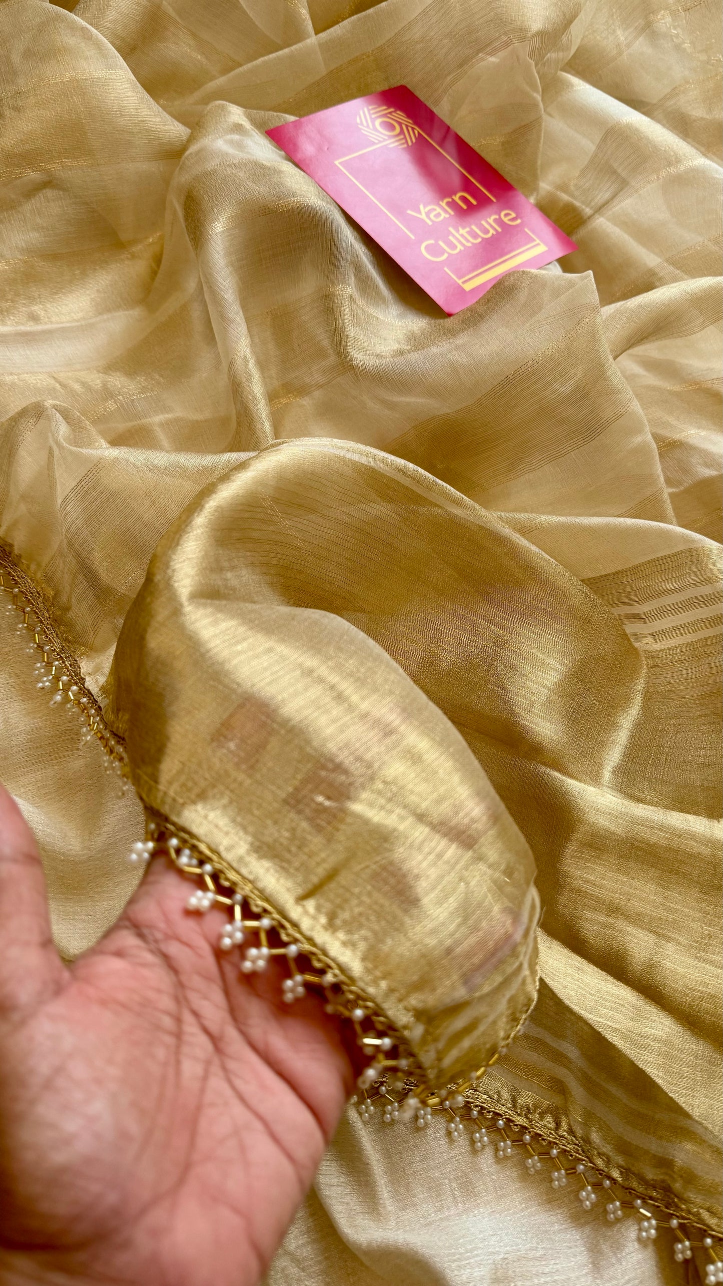 Gold soft semi tissue saree, striped body, pearl embellished border - YCIEON83