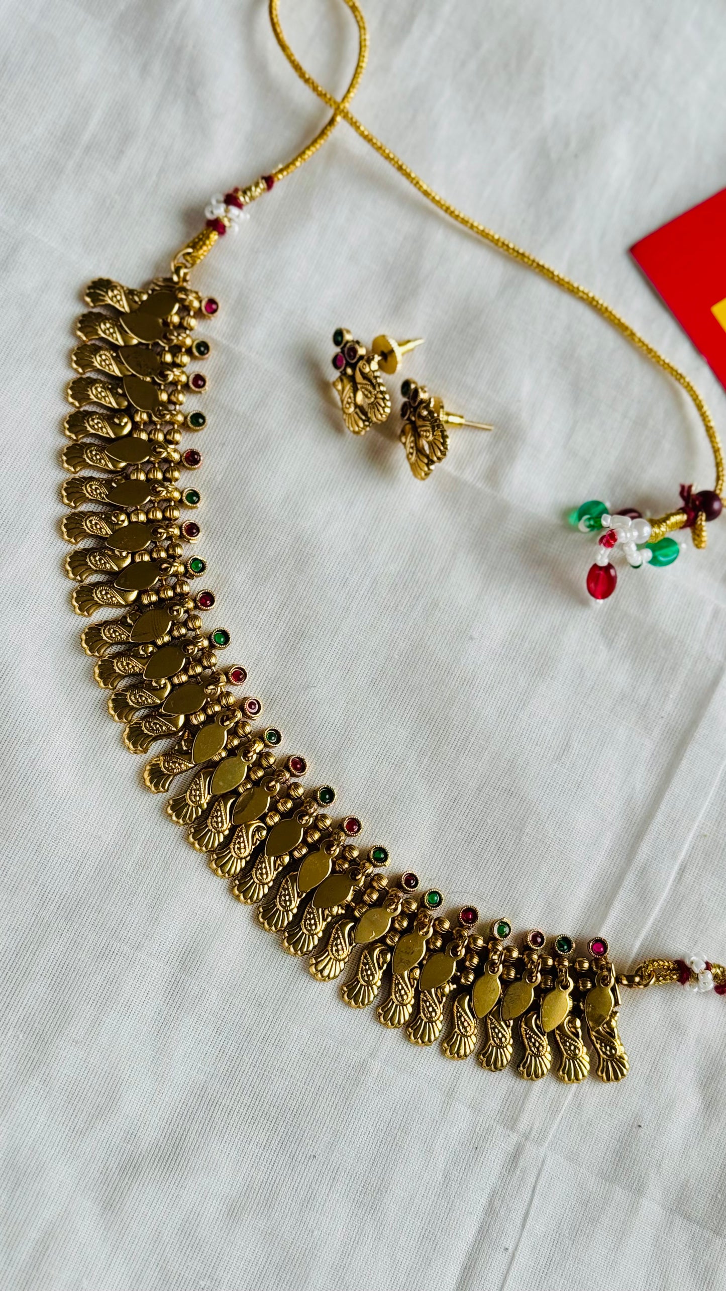 Elakkathali with peacock shaped pendant, ruby and green stones, with earrings - YCGPNP794