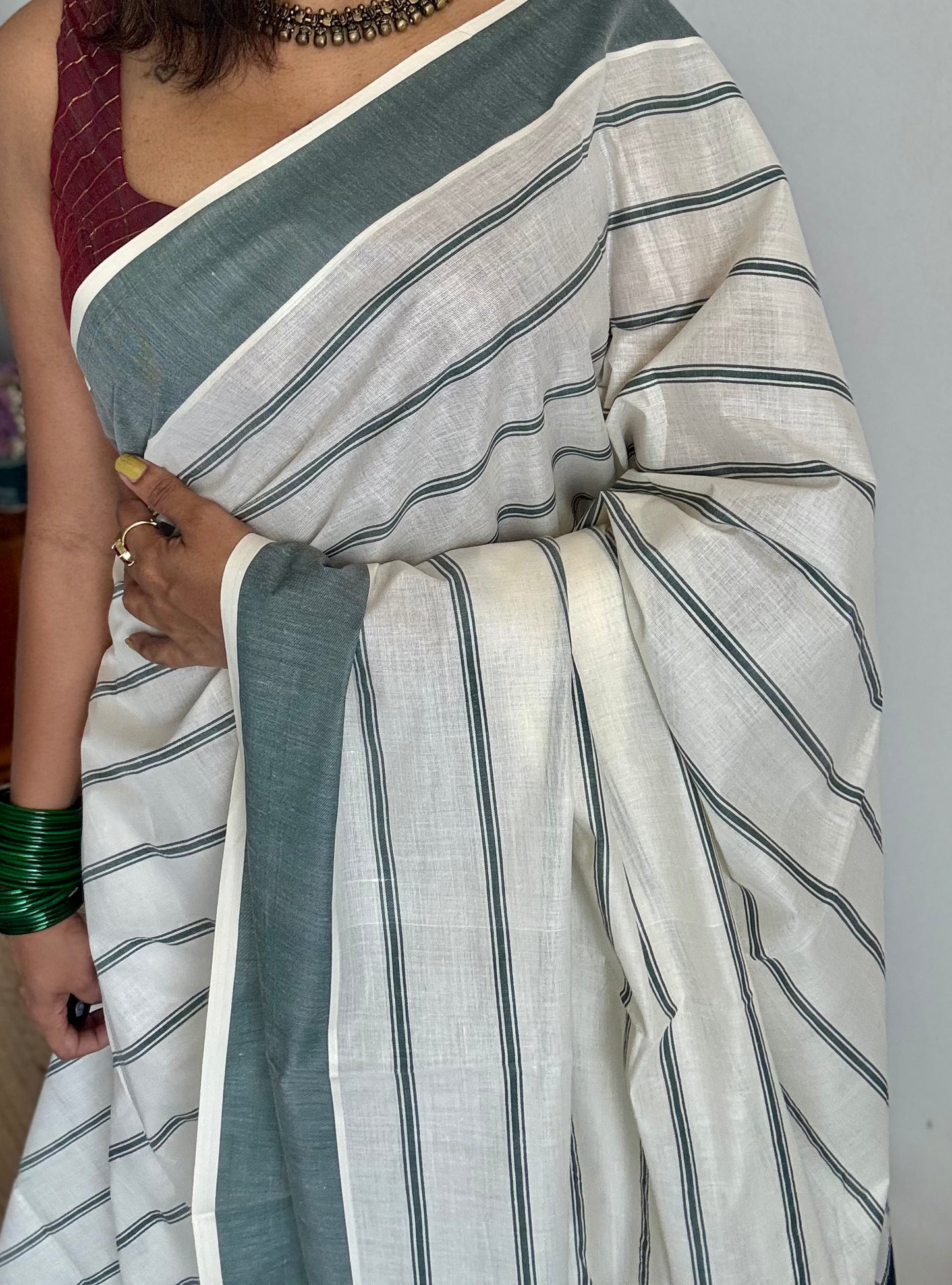 Ivory Kerala cotton saree with green stripes and border - YCIEKCFE323