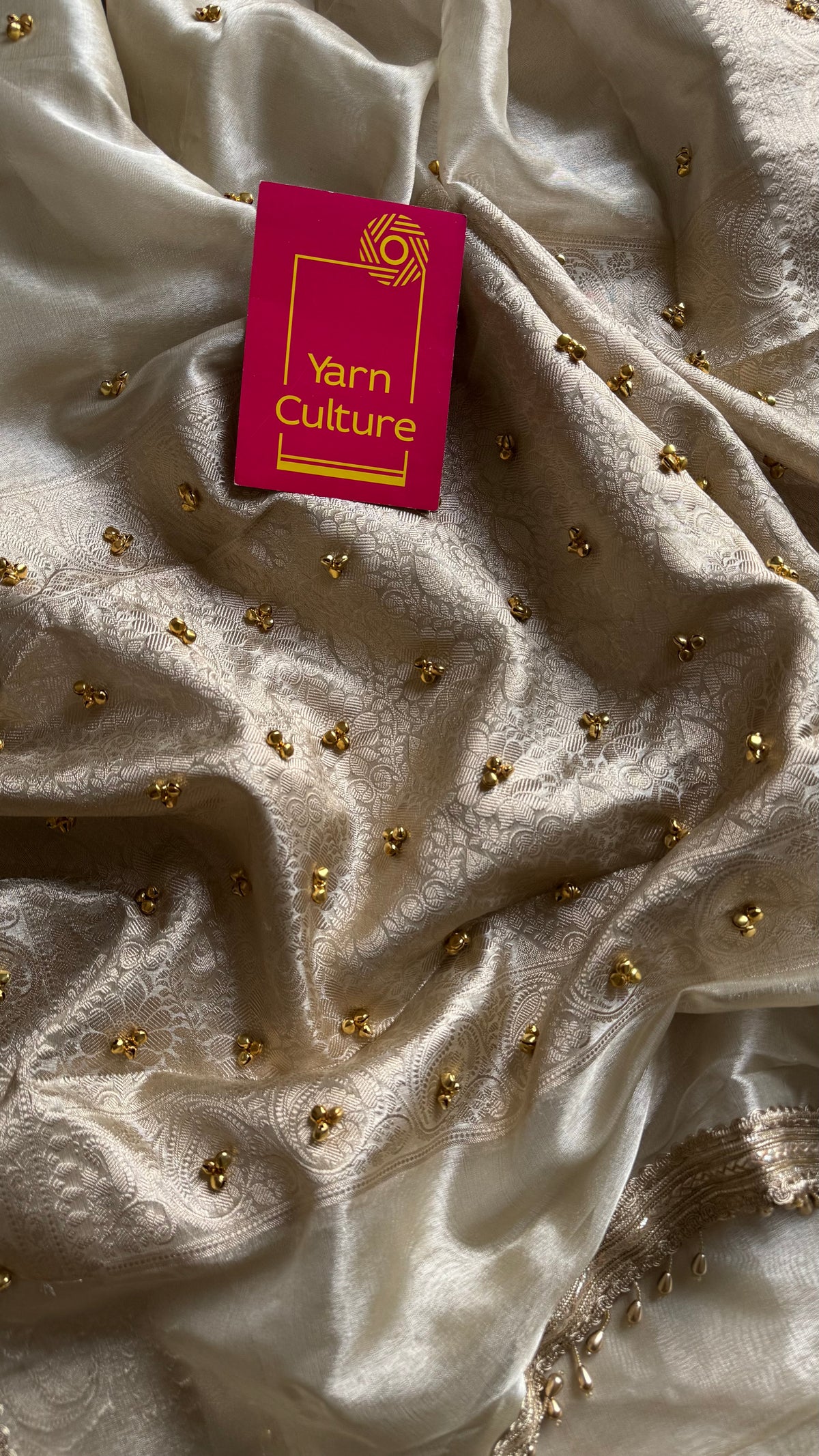 Ivory gold tissue Banarasi saree with ghungroo embellishments and beaded lace zari border - YCBLTOC70