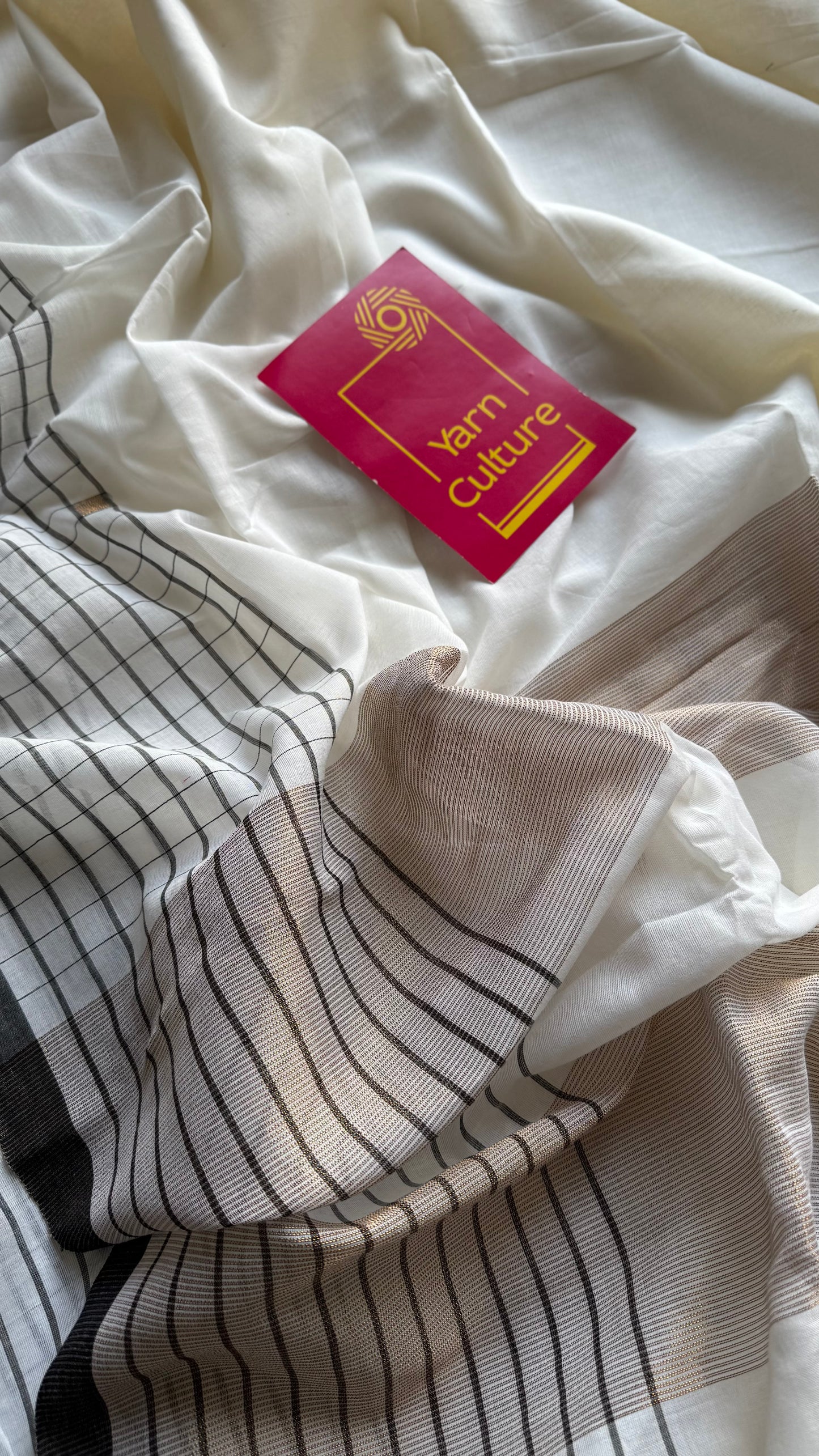 Ivory handloom mul saree with black checkered borders and antique gold buttas - YCBCMCFE170