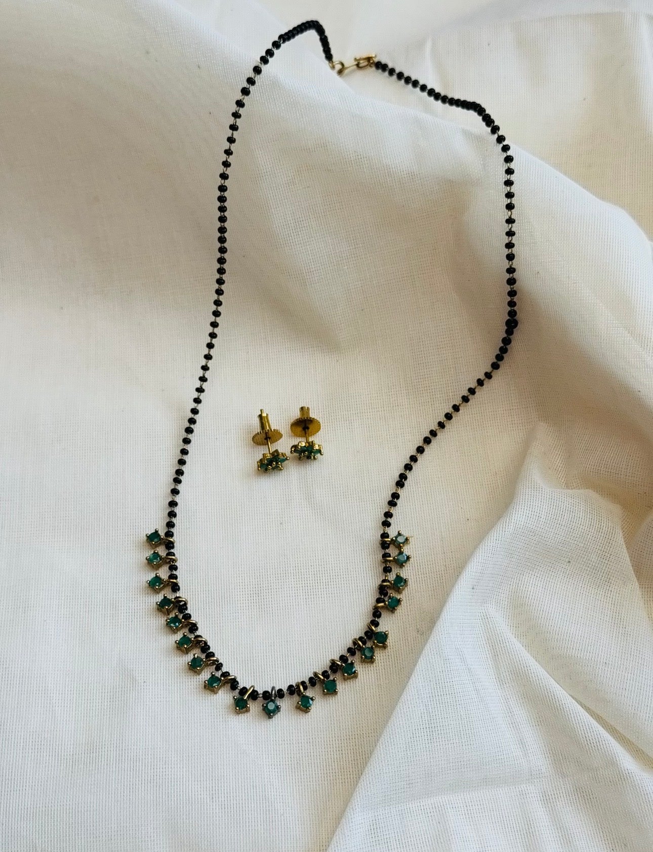 Black beaded (karimani) neckchain with green stone pendants, with earrings - YCGPNP809