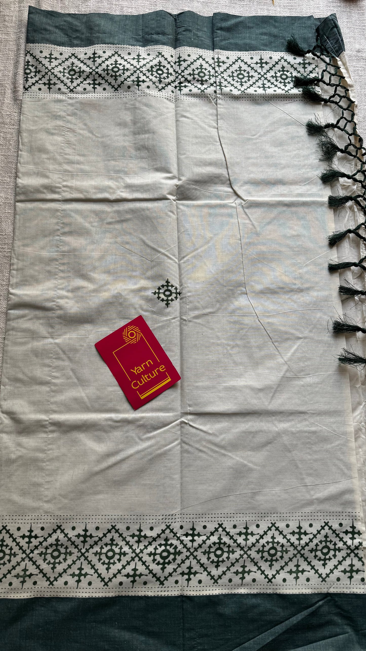 Ivory Kerala cotton saree with green Kutch-inspired printed borders and green centre pleats - YCIEKCFE314