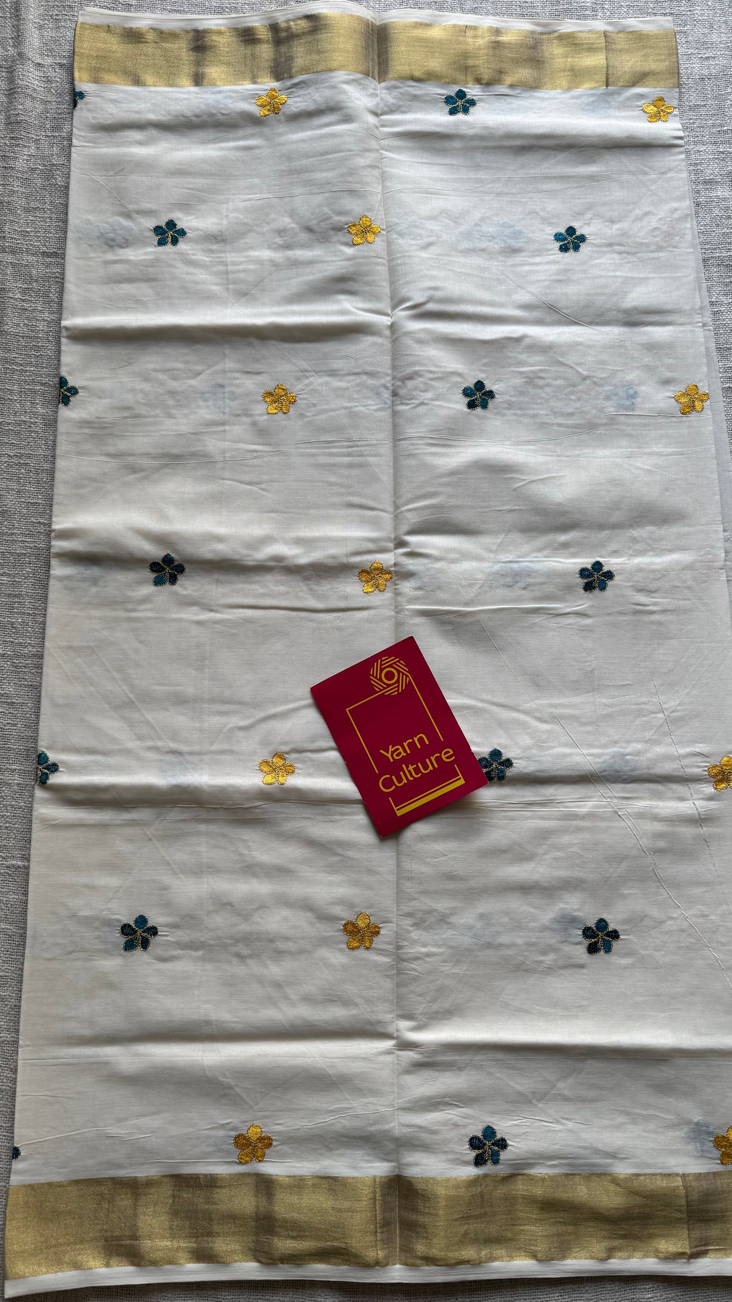 Ivory and gold saree with peacock blue and yellow floral embroidery - YCIEKCFE309