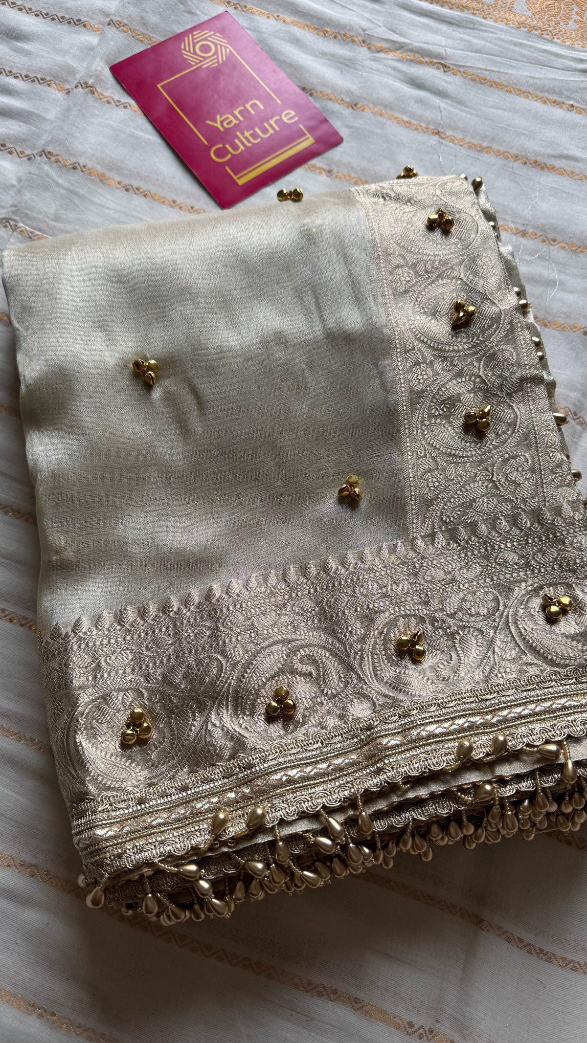 Ivory gold tissue Banarasi saree with ghungroo embellishments and beaded lace zari border - YCBLTOC70