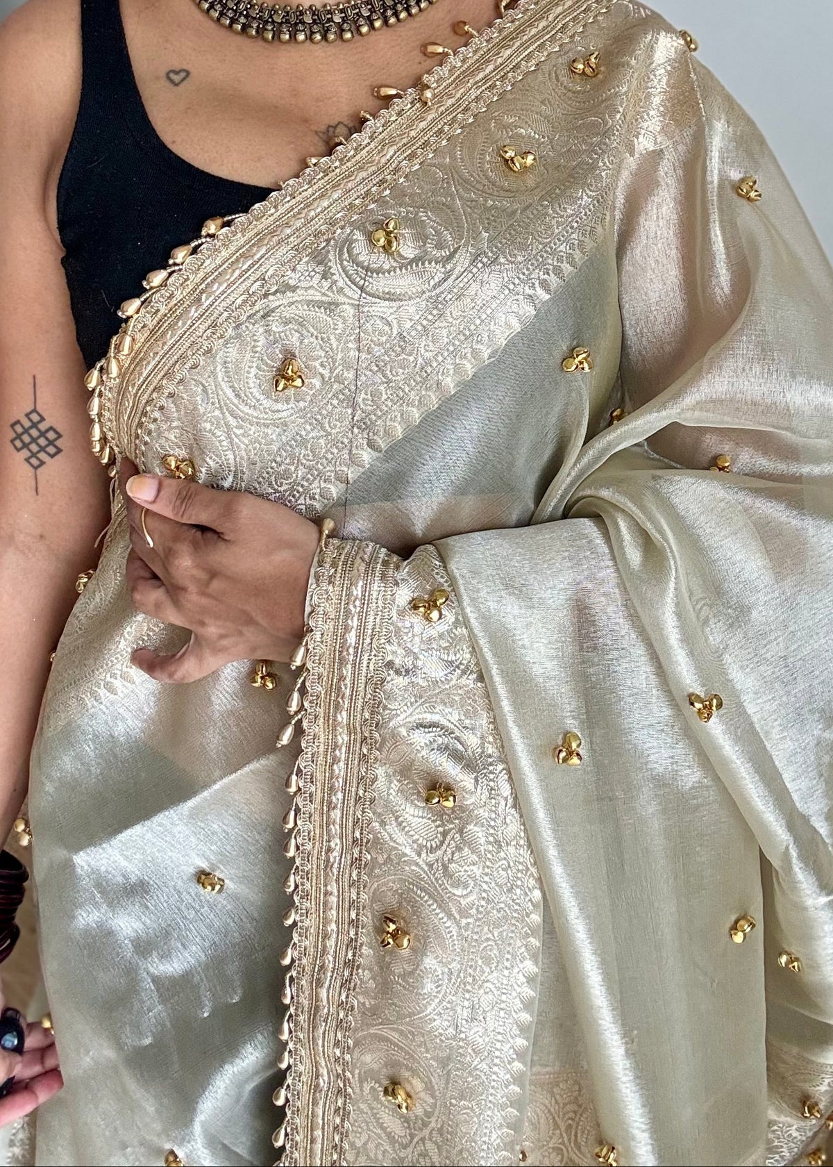 Ivory gold tissue Banarasi saree with ghungroo embellishments and beaded lace zari border - YCBLTOC70