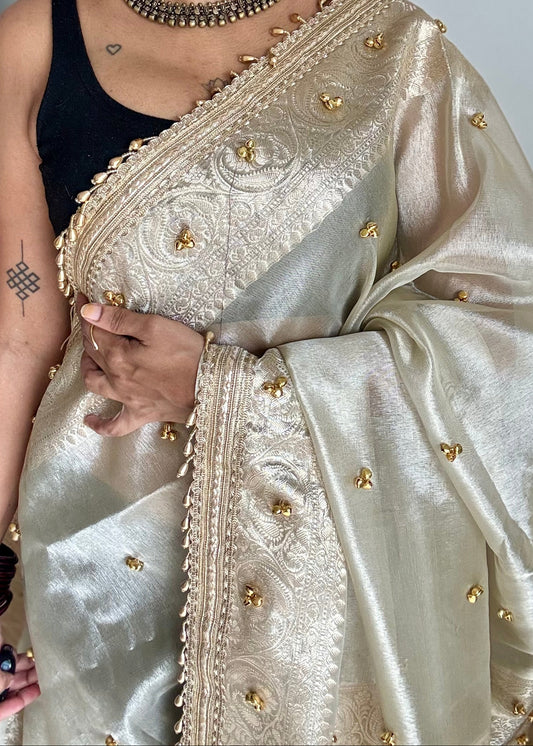 Ivory gold tissue Banarasi saree with ghungroo embellishments and beaded lace zari border - YCBLTOC70