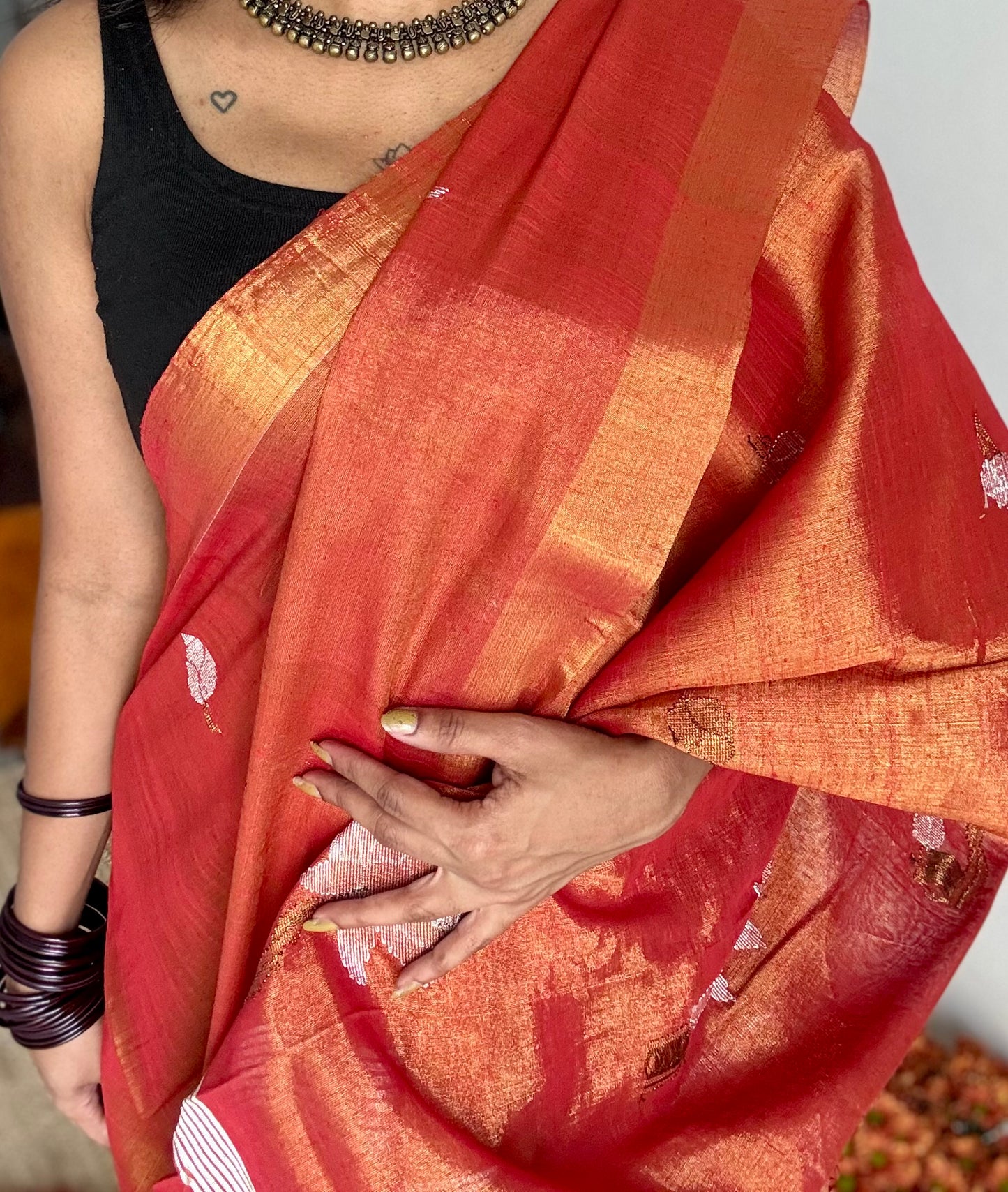 Handwoven orange gold dual tone tissue linen saree with lotus motifs - YCBCLTFE399