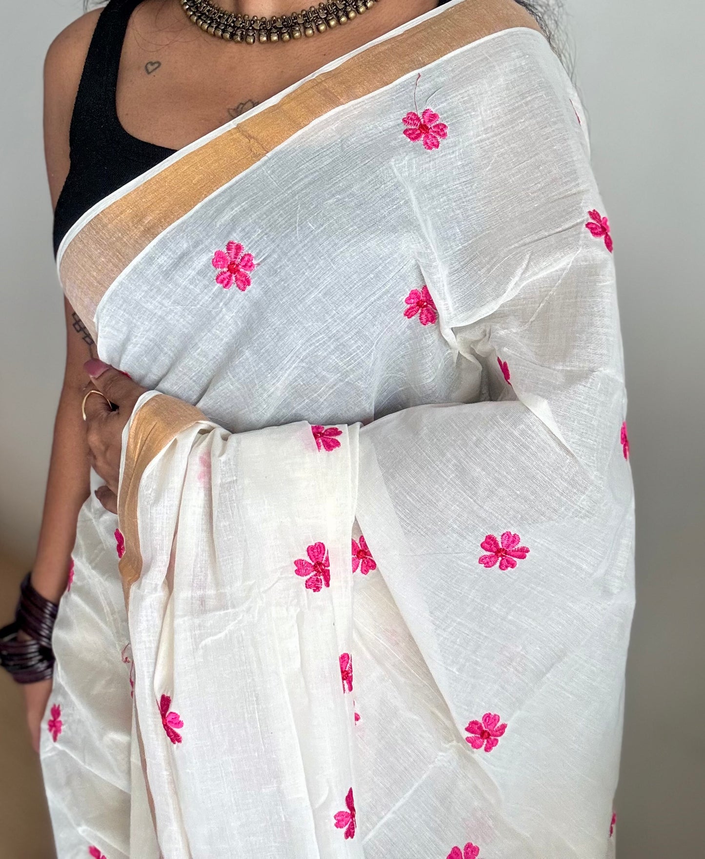 Ivory and antique gold soft cotton kasavu saree, pink parijat floral embroidery - YCIEON155