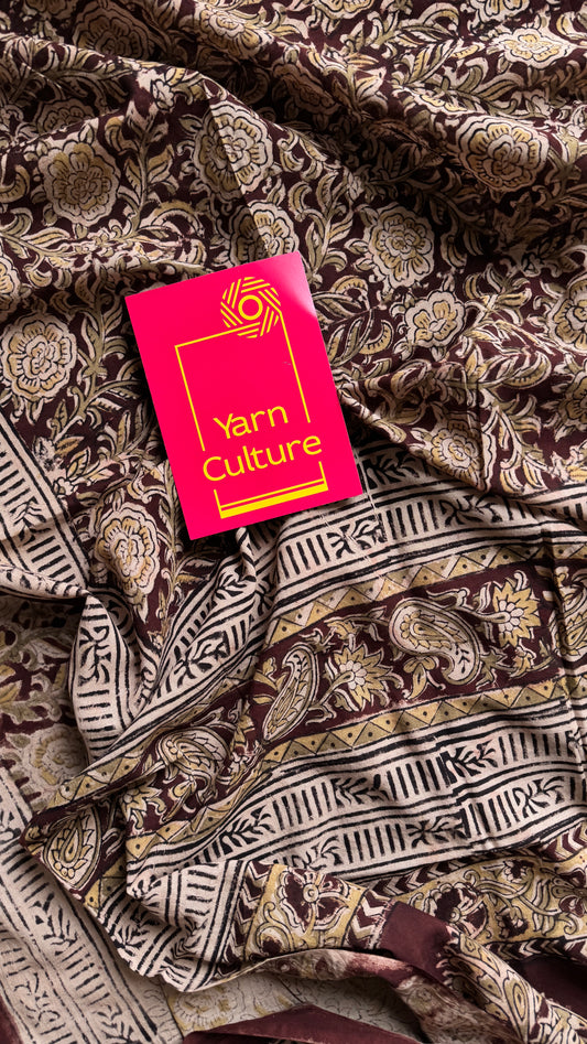 Dark maroon kalamkari, yellow floral vines, floral motif pallu